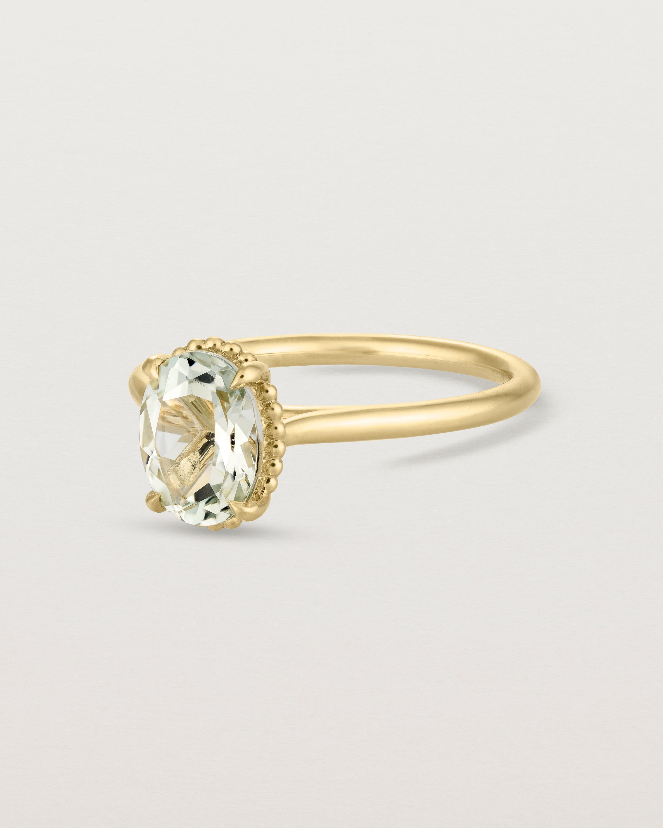 Angled view of the Thea Oval Solitaire | Green Amethyst in yellow gold.