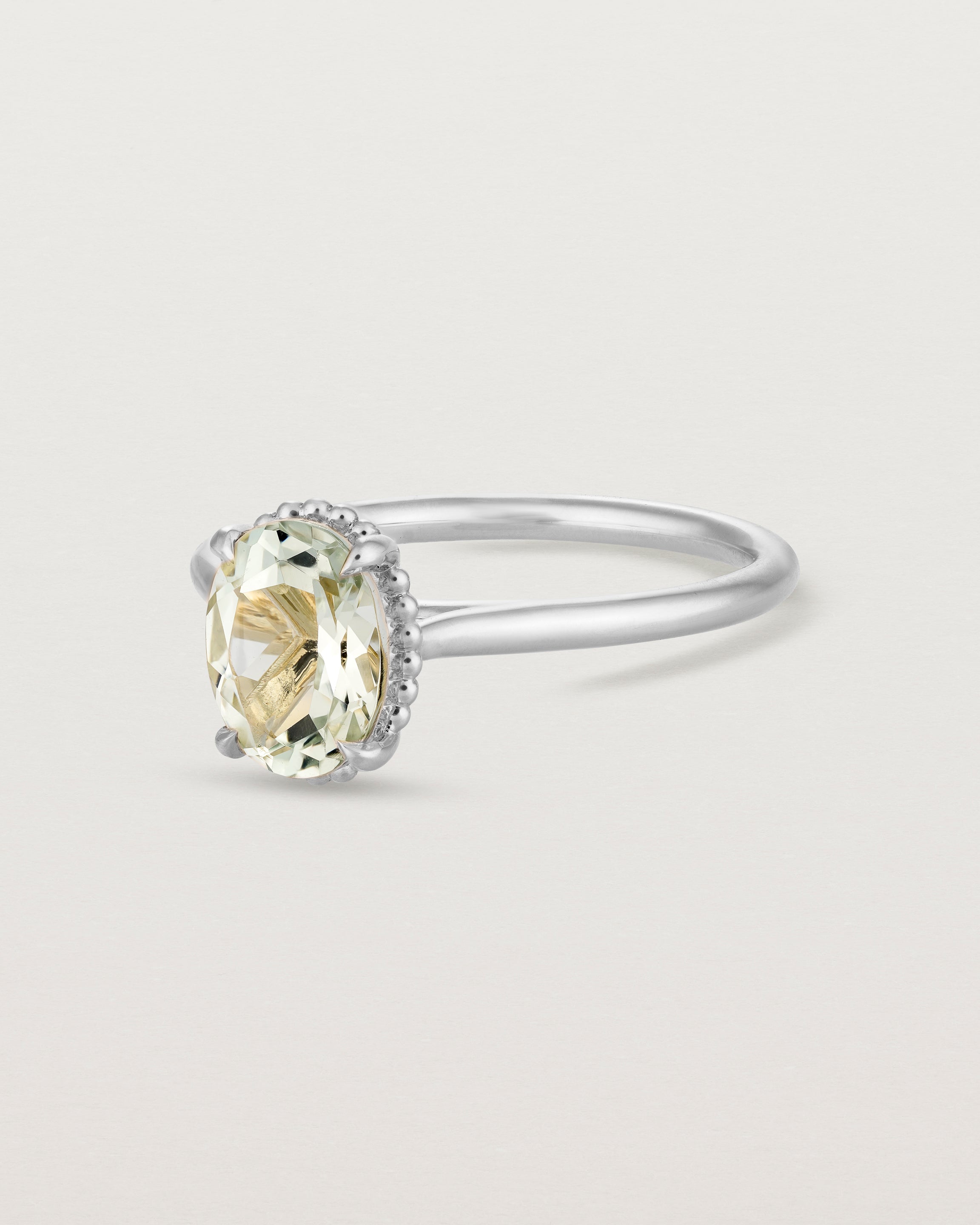 Angled view of the Thea Oval Solitaire | Green Amethyst in white gold.