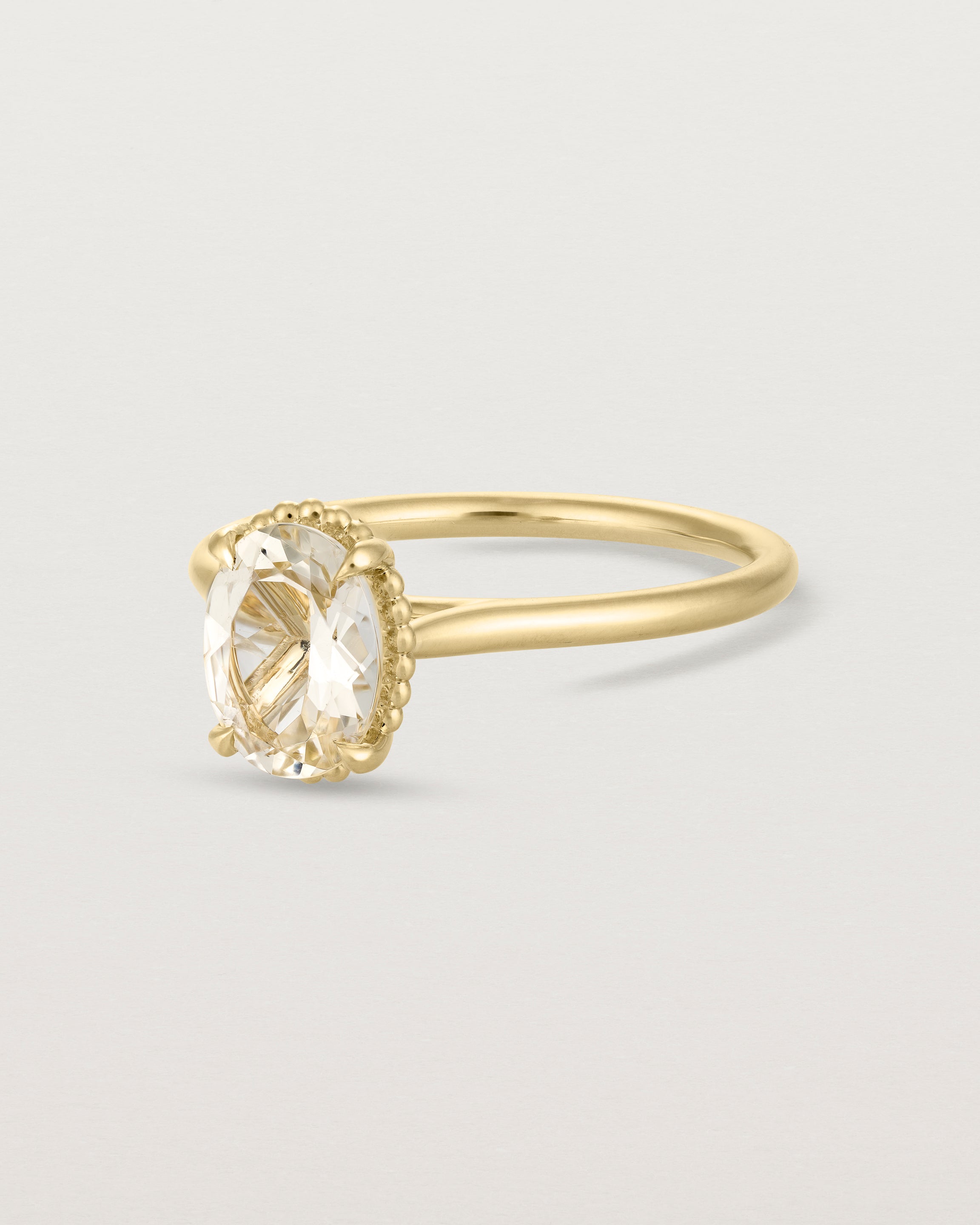 Angled view of the Thea Oval Solitaire | Savannah Sunstone in yellow gold.