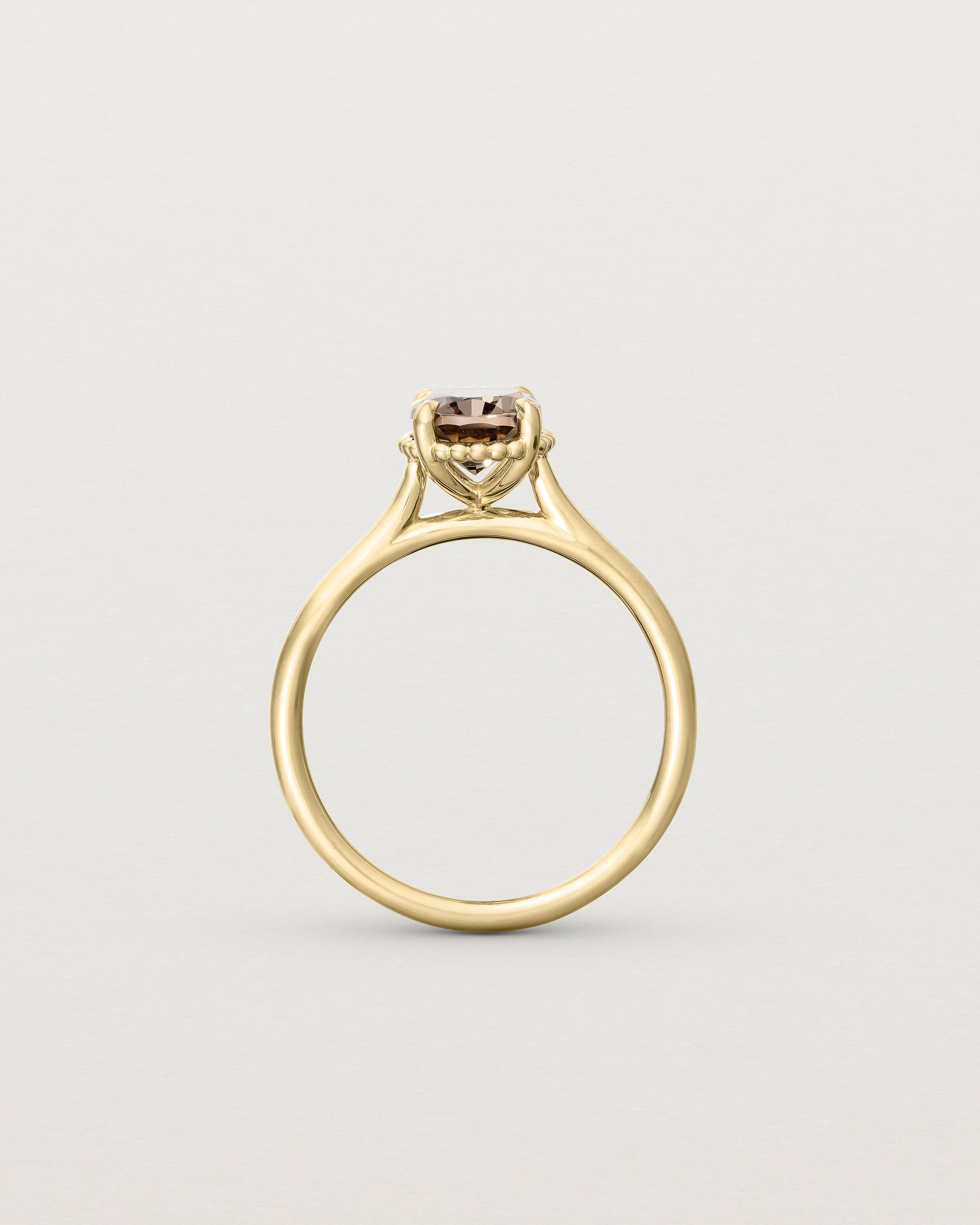 Standing view of the Thea Oval Solitaire | Smokey Quartz in yellow gold.