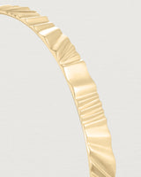Close up view of the Pan Bangle in yellow gold.