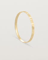 Standing view of the Pan Bangle in yellow gold.