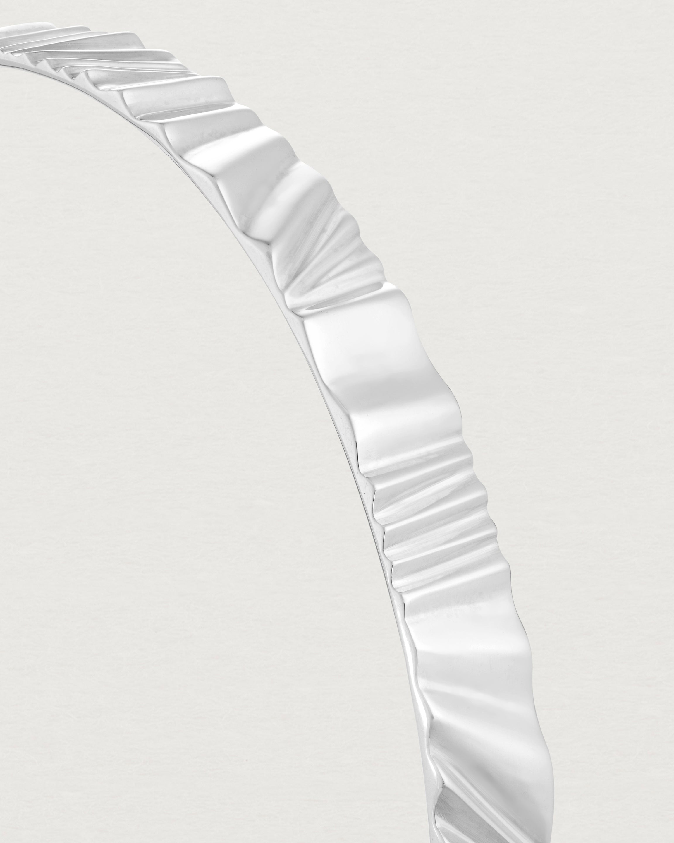 Close up view of the Pan Bangle in sterling silver.