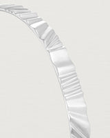 Close up view of the Pan Bangle in sterling silver.