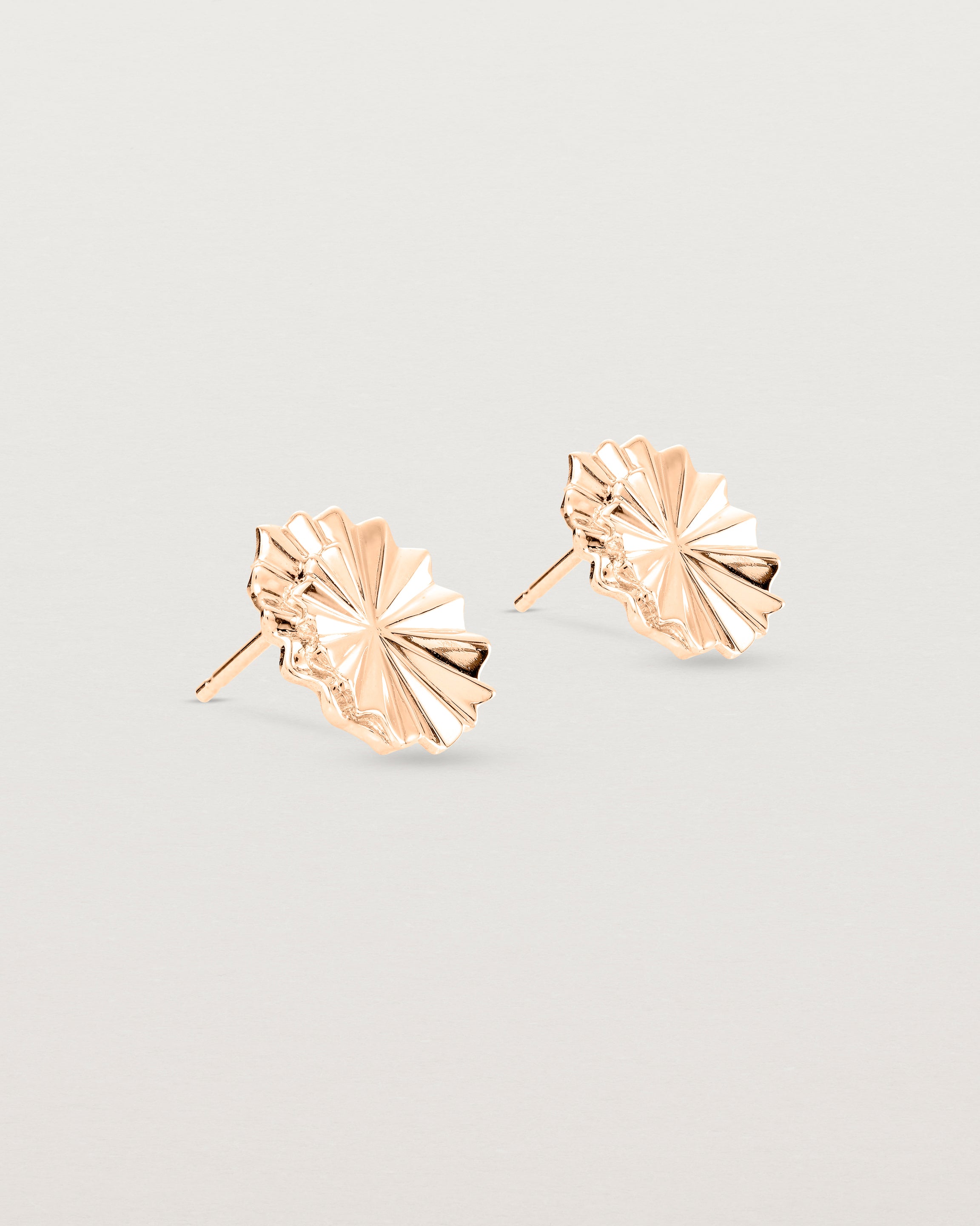 Angled view of the Pan Earrings in rose gold.