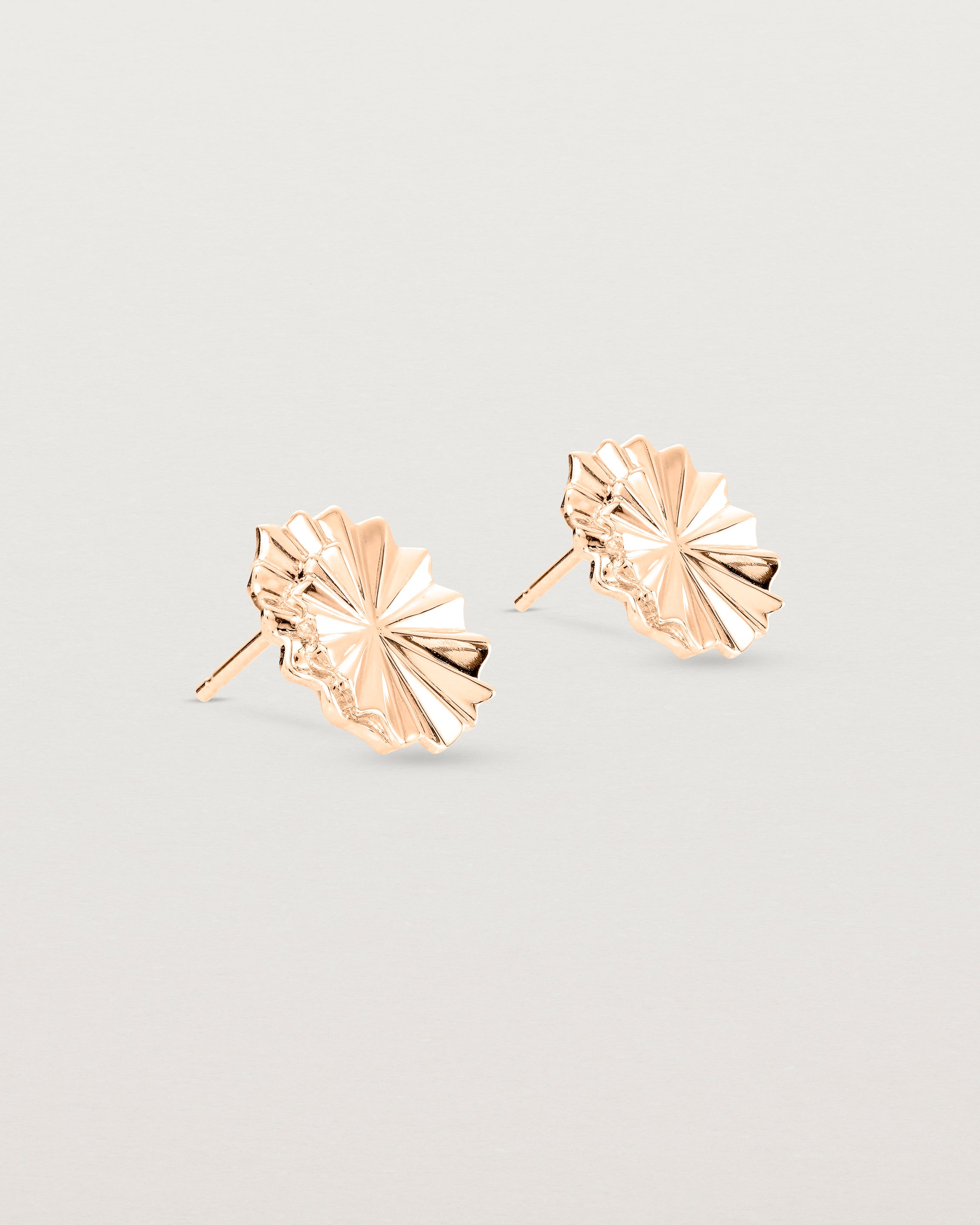 Angled view of the Pan Earrings in rose gold.