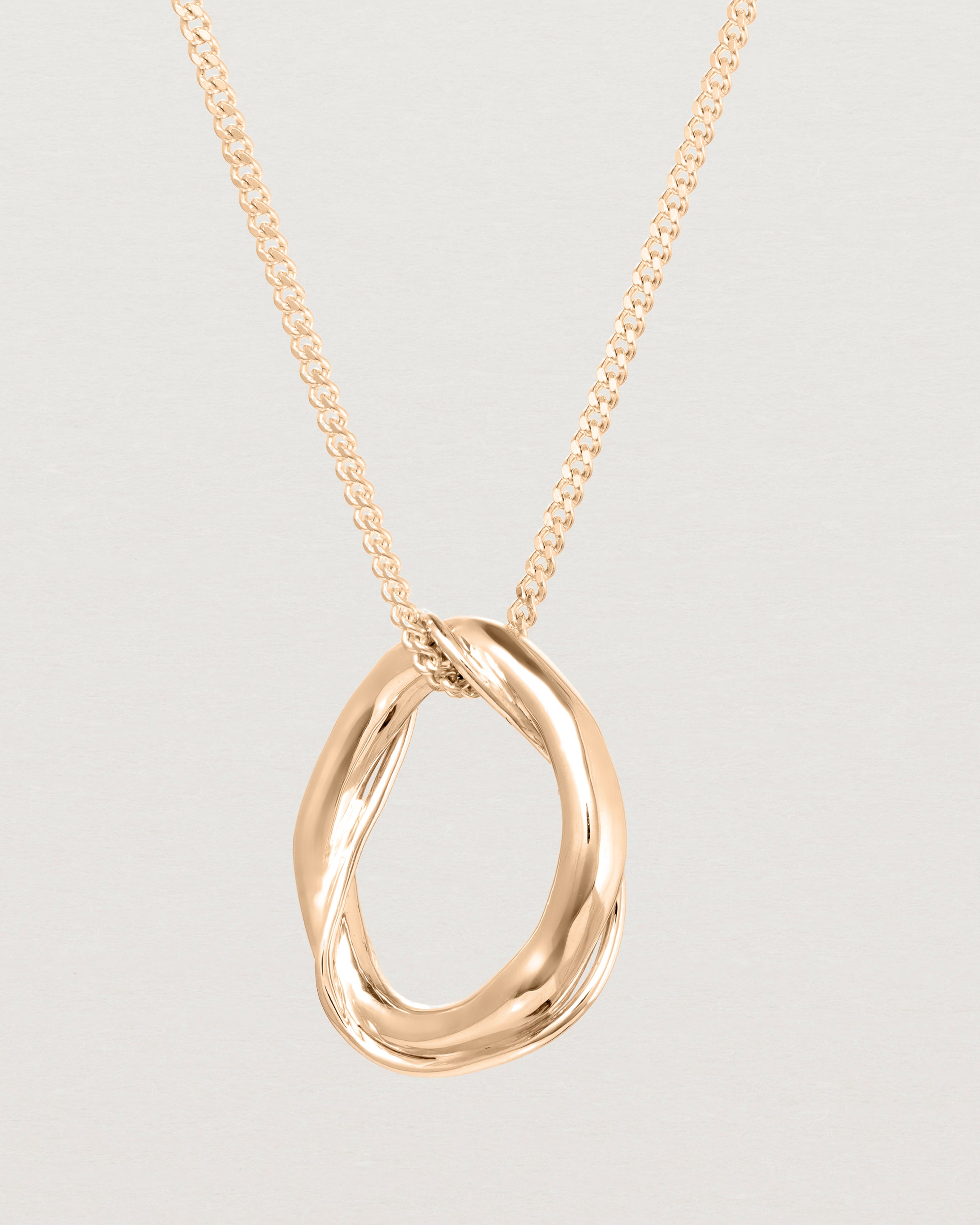 Close up view of the Petite Dalí Necklace in rose gold.