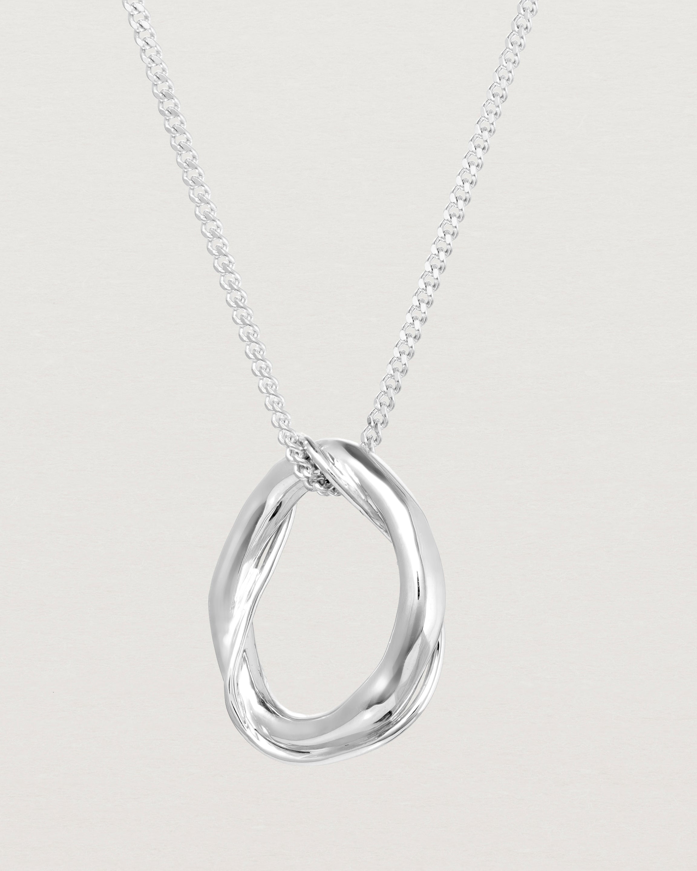 Close up view of the Petite Dalí Necklace in sterling silver.
