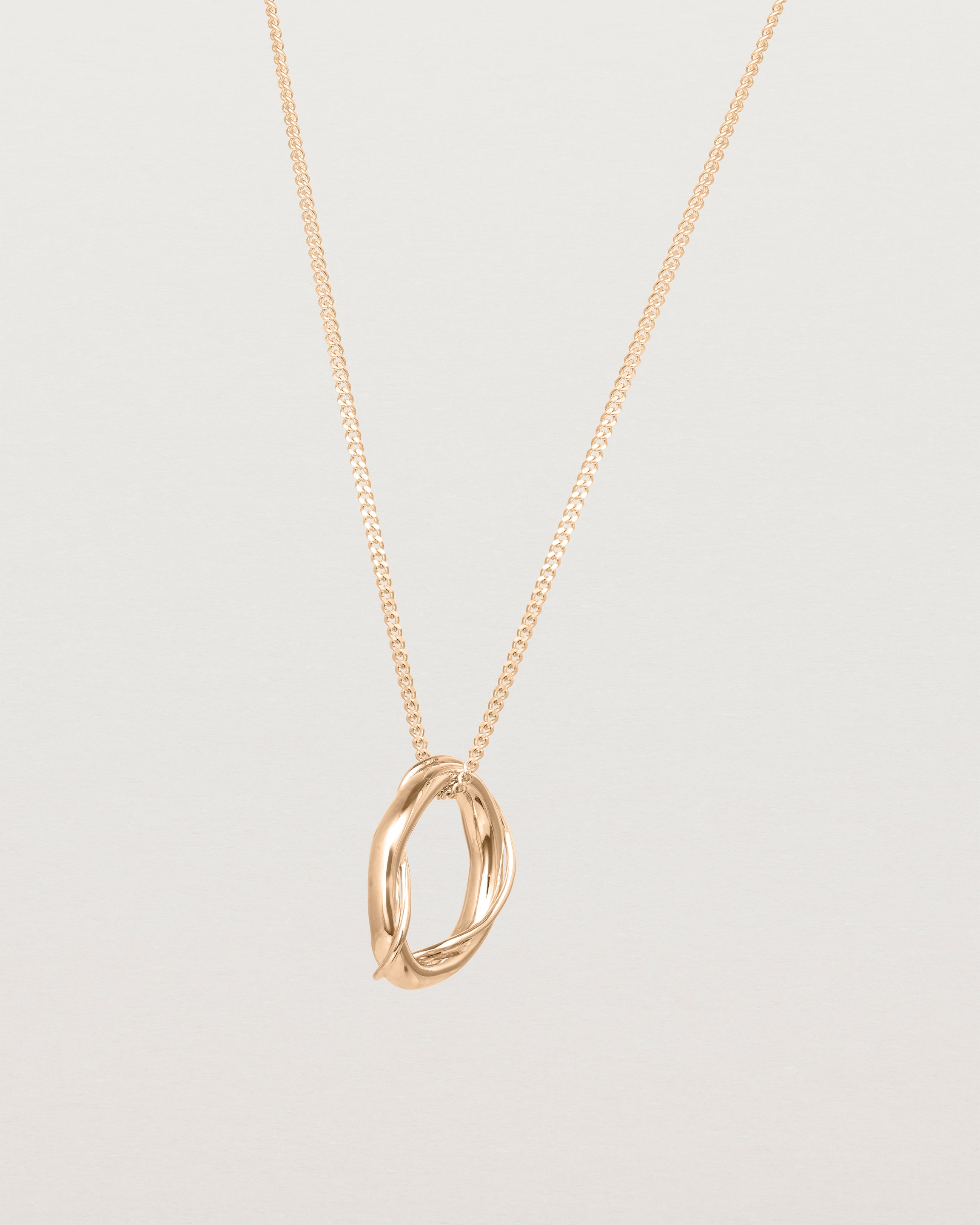 Angled view of the Petite Dalí Necklace in rose gold.