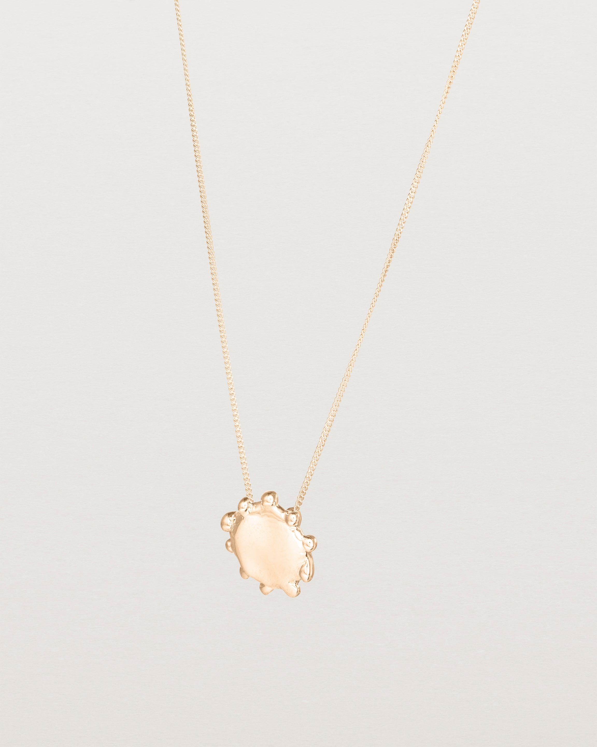 Angled view of the Petite Dotted Mana Necklace | Rose Gold