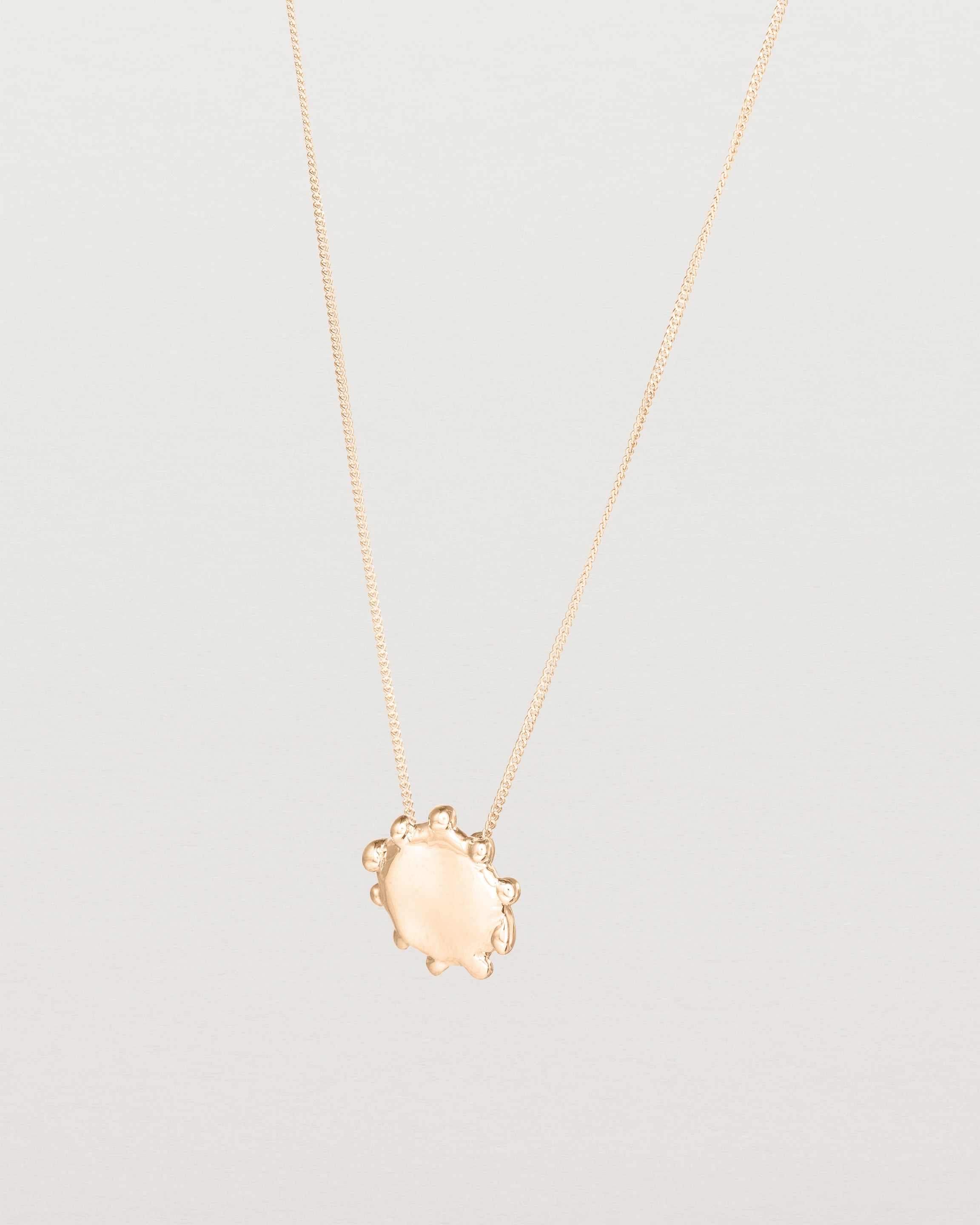 Angled view of the Petite Dotted Mana Necklace | Rose Gold