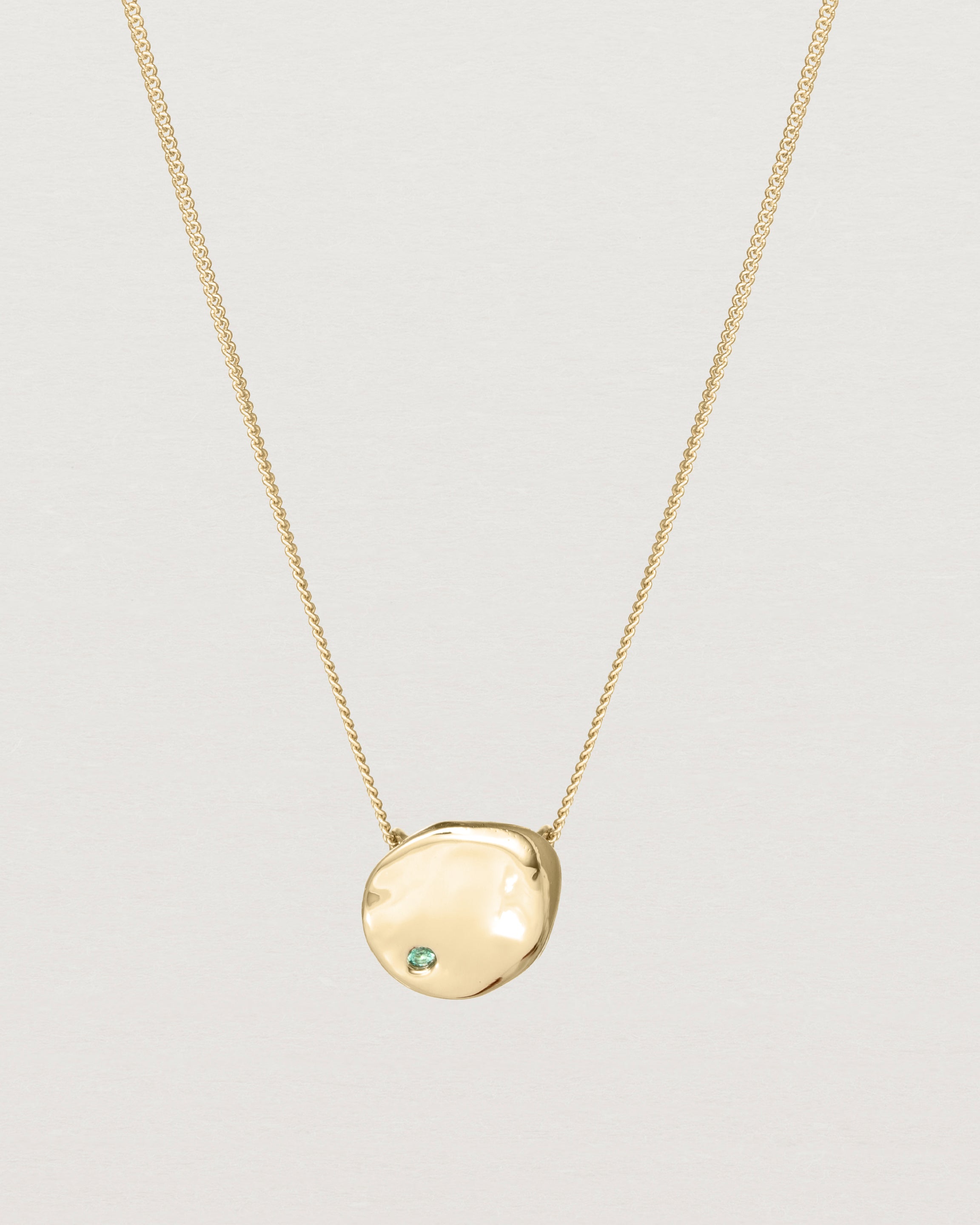 Front view of the Petite Mana Necklace in yellow gold. stone _label: Accent Stone Example