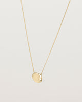 Angled view of the Petite Mana Necklace in yellow gold.