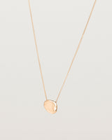 Angled view of the Petite Mana Necklace in rose gold.