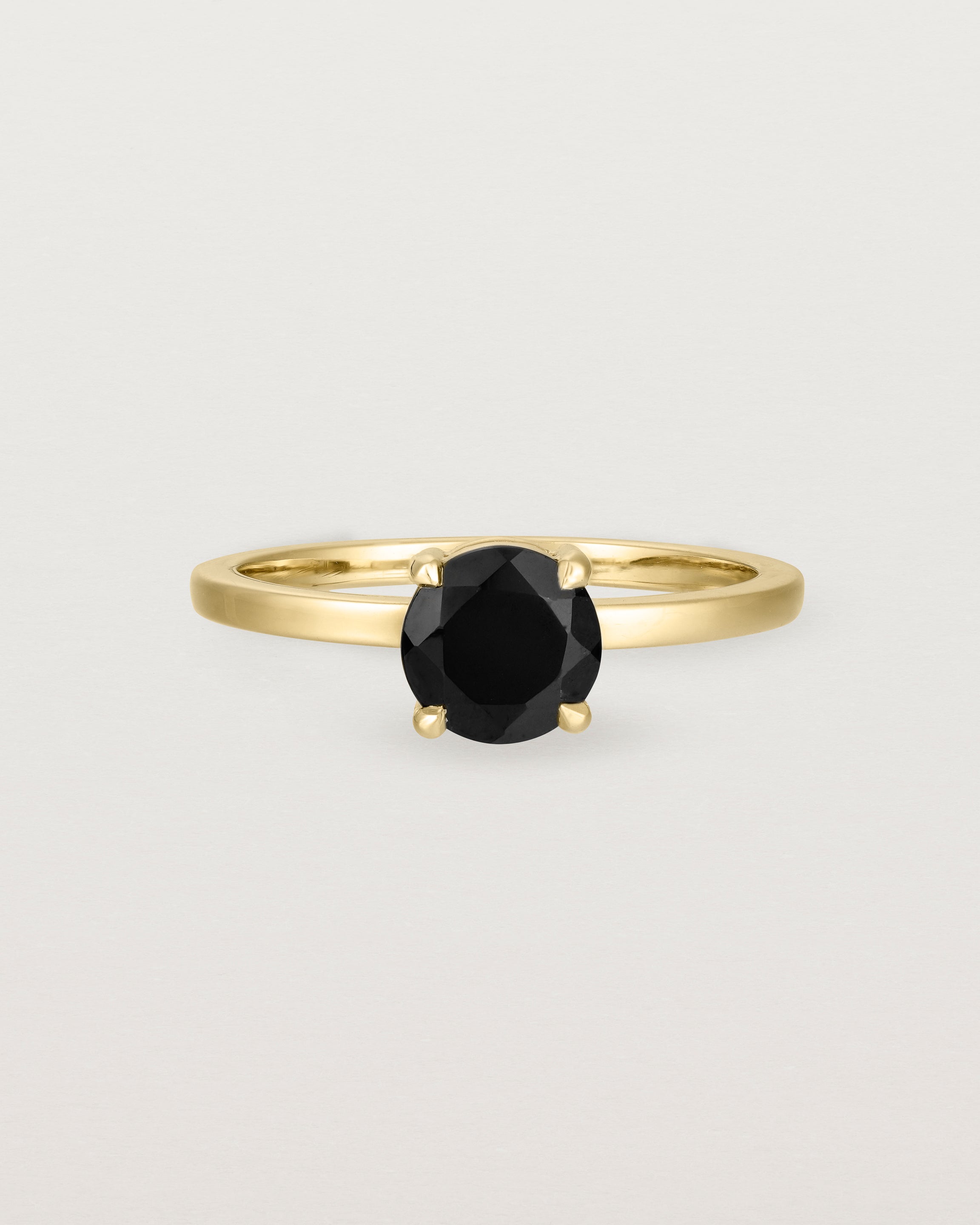 Front view of the Petite Una Round Solitaire | Black Spinel | Yellow Gold.