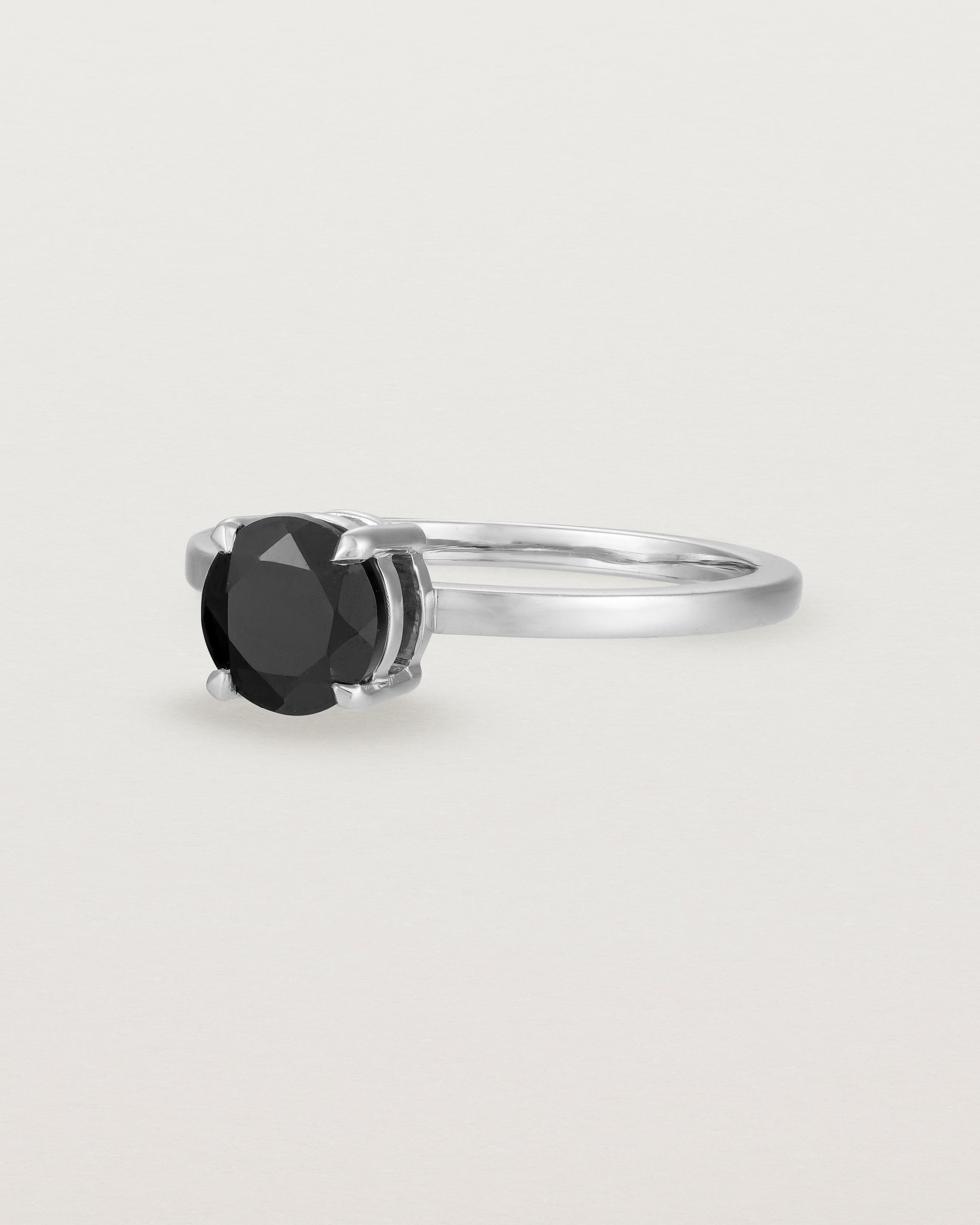 Angled view of the Petite Una Round Solitaire | Black Spinel | White Gold.