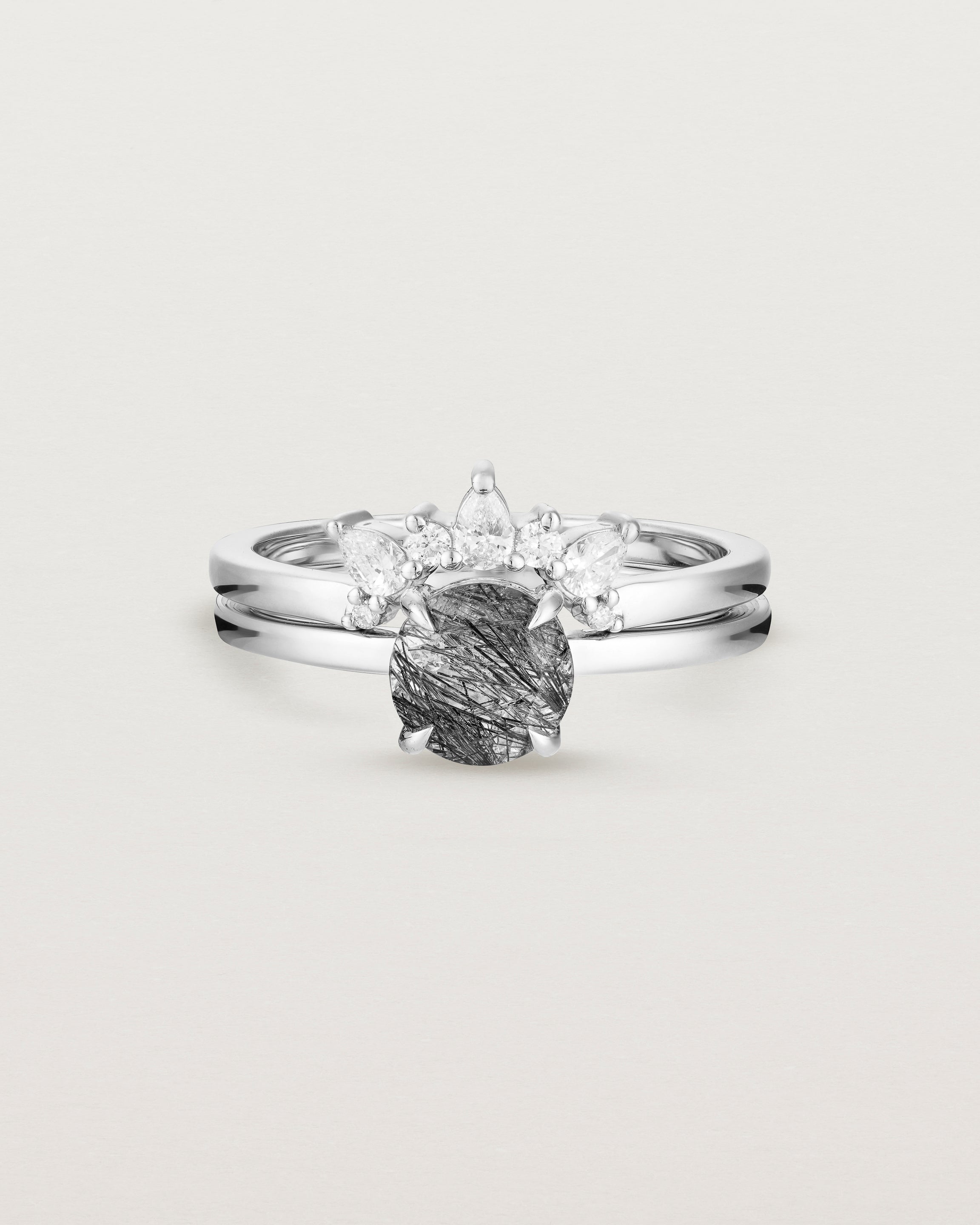 Front view of the Petite Una Round Solitaire | Tourmalinated Quartz | White Gold stacked with the Odette Crown Ring | Diamonds.