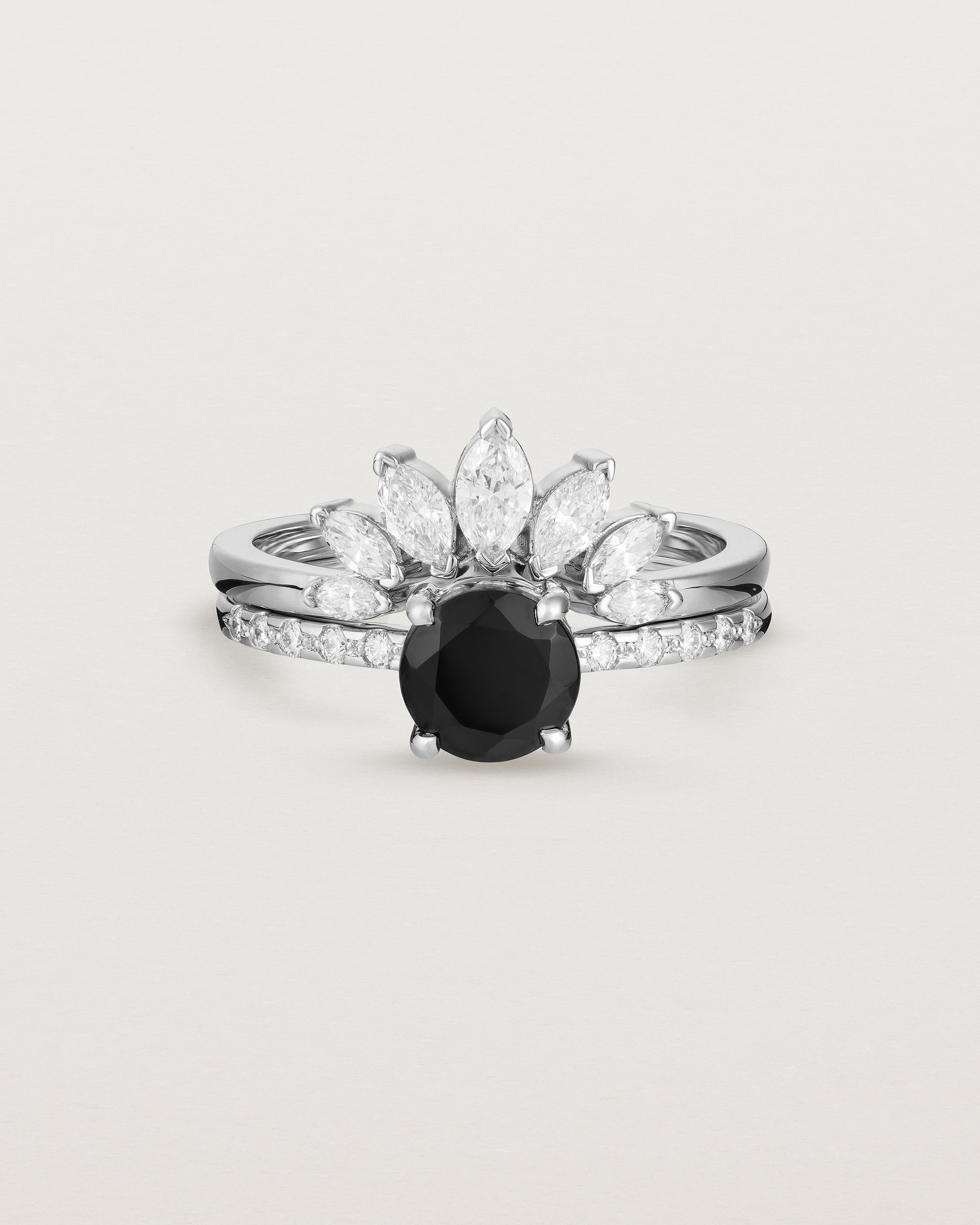 Front view of the Petite Una Round Solitaire | Black Spinel | White Gold with Cascade Shoulders stacked with the Camille Crown Ring | Diamonds. 