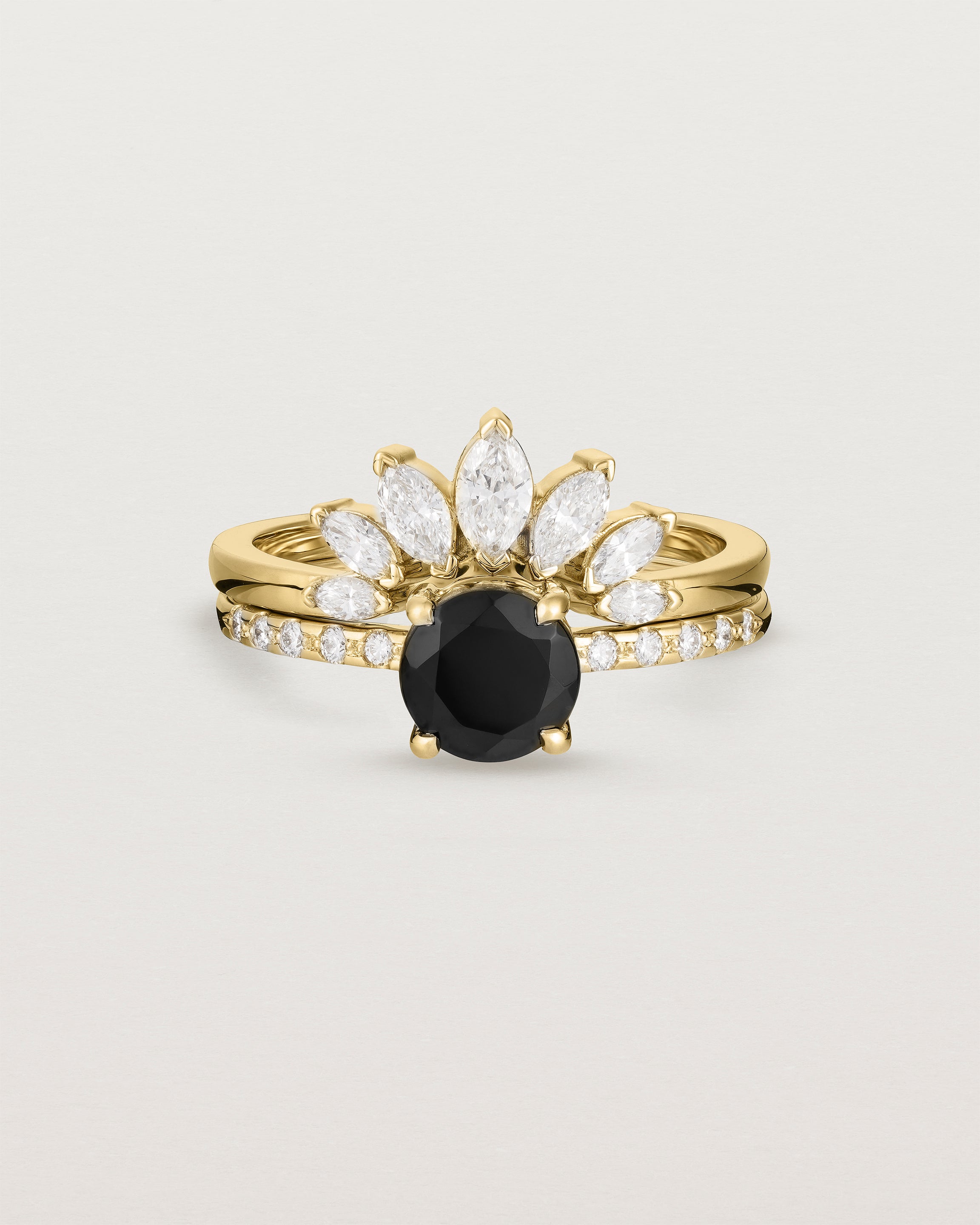 Front view of the Petite Una Round Solitaire | Black Spinel | Yellow Gold with Cascade Shoulders stacked with the Camille Crown Ring | Diamonds. 