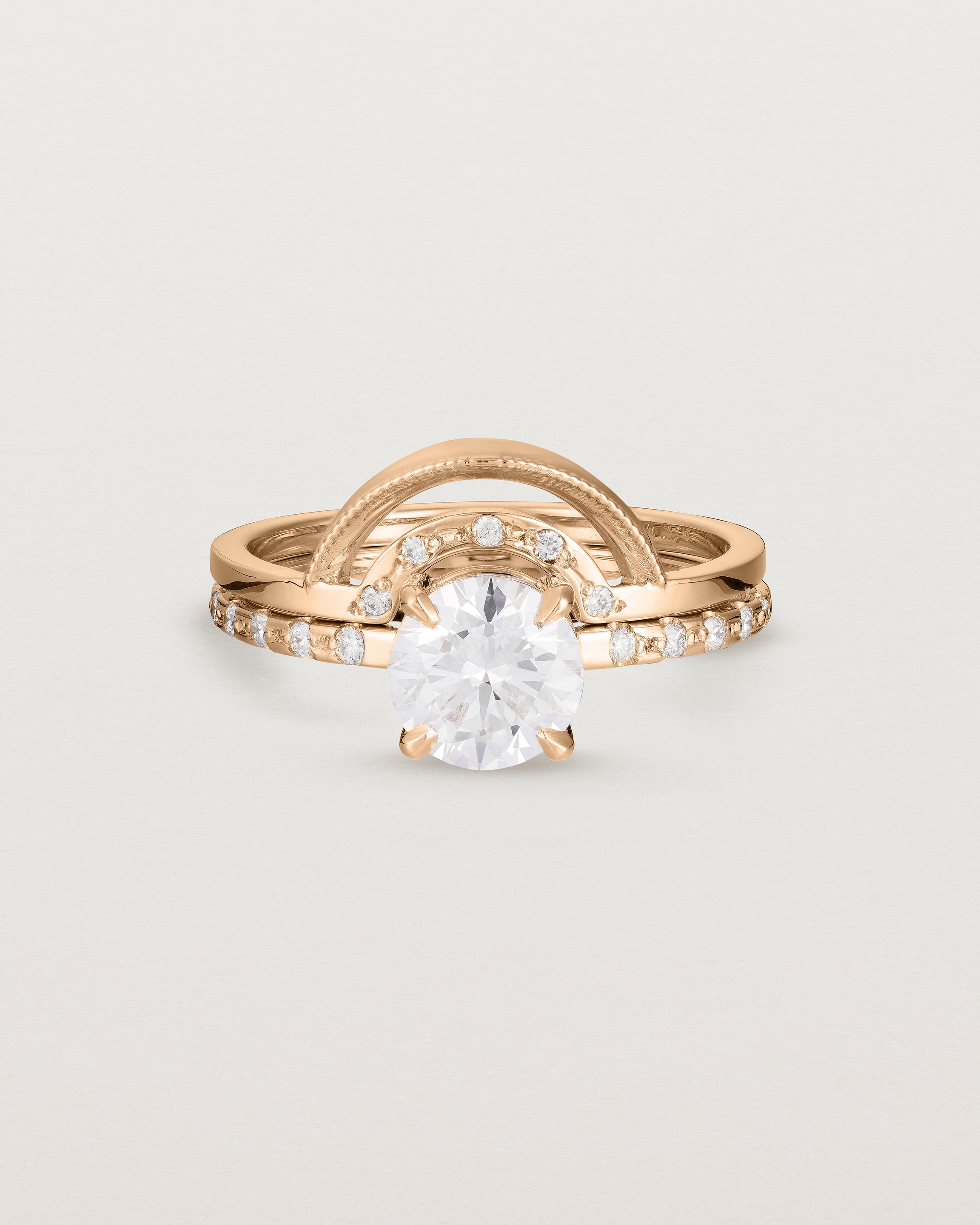Front view of the Petite Una Round Solitaire | Laboratory Grown Diamond | Rose Gold with Cascade Shoulders stacked with the Evette Crown Ring | Diamonds. 