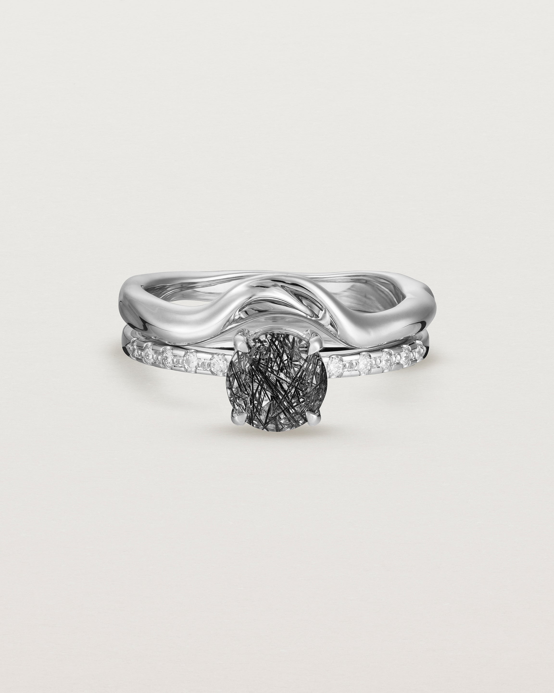 Front view of the Petite Una Round Solitaire | Tourmalinated Quartz | White Gold with Cascade Shoulders stacked with the Organic Crown Ring. 