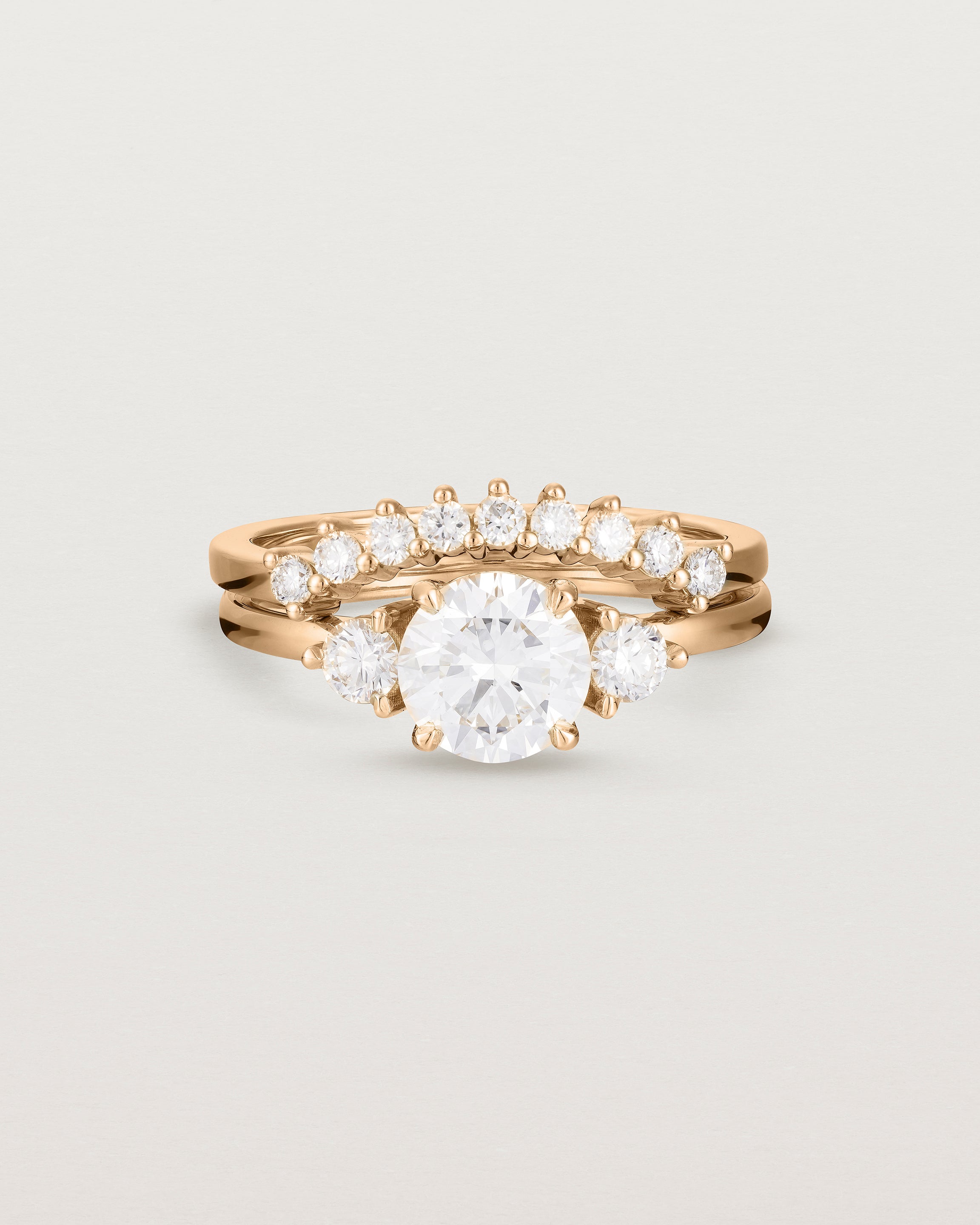 Front view of the Petite Una Round Trio Ring | Laboratory Grown Diamonds | Rose Gold with the Reina Crown Ring | Diamonds. 