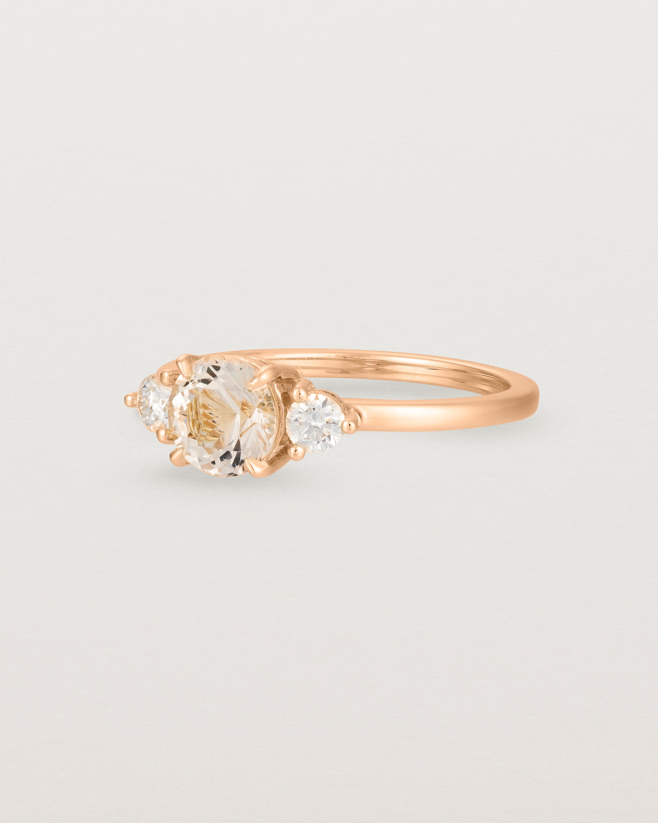 Angled view of the Petite Una Round Trio Ring | Morganite & Diamonds | Rose Gold.