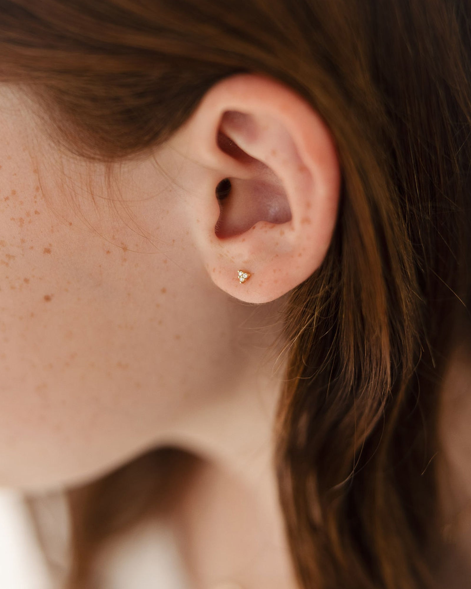 child model wearing petits Kalani Studs with diamonds in rose gold