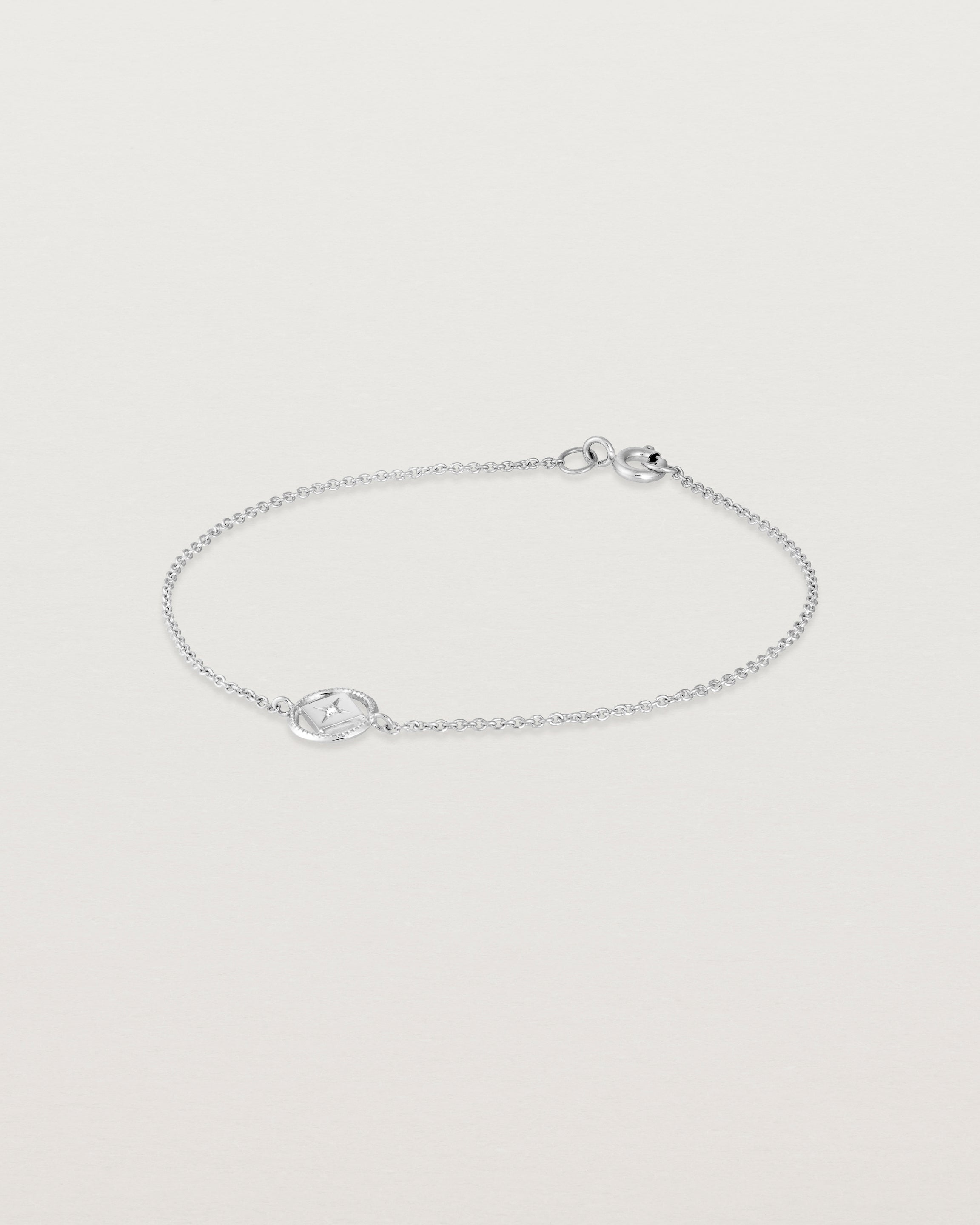 Angled view of the Polaris Bracelet | Birthstone in white gold with a white diamond.
