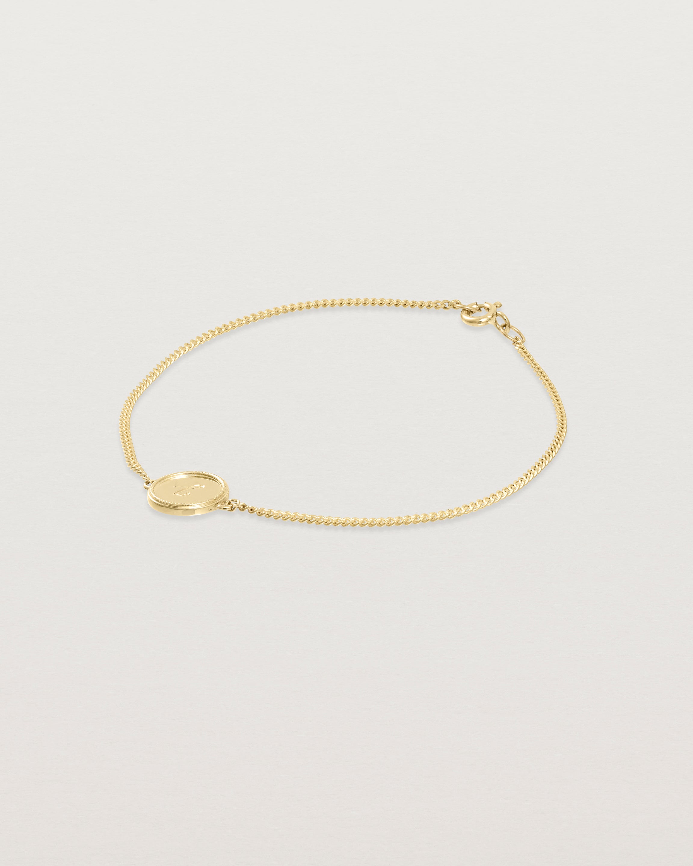 Angled view of the Precious Initial Bracelet in yellow gold.