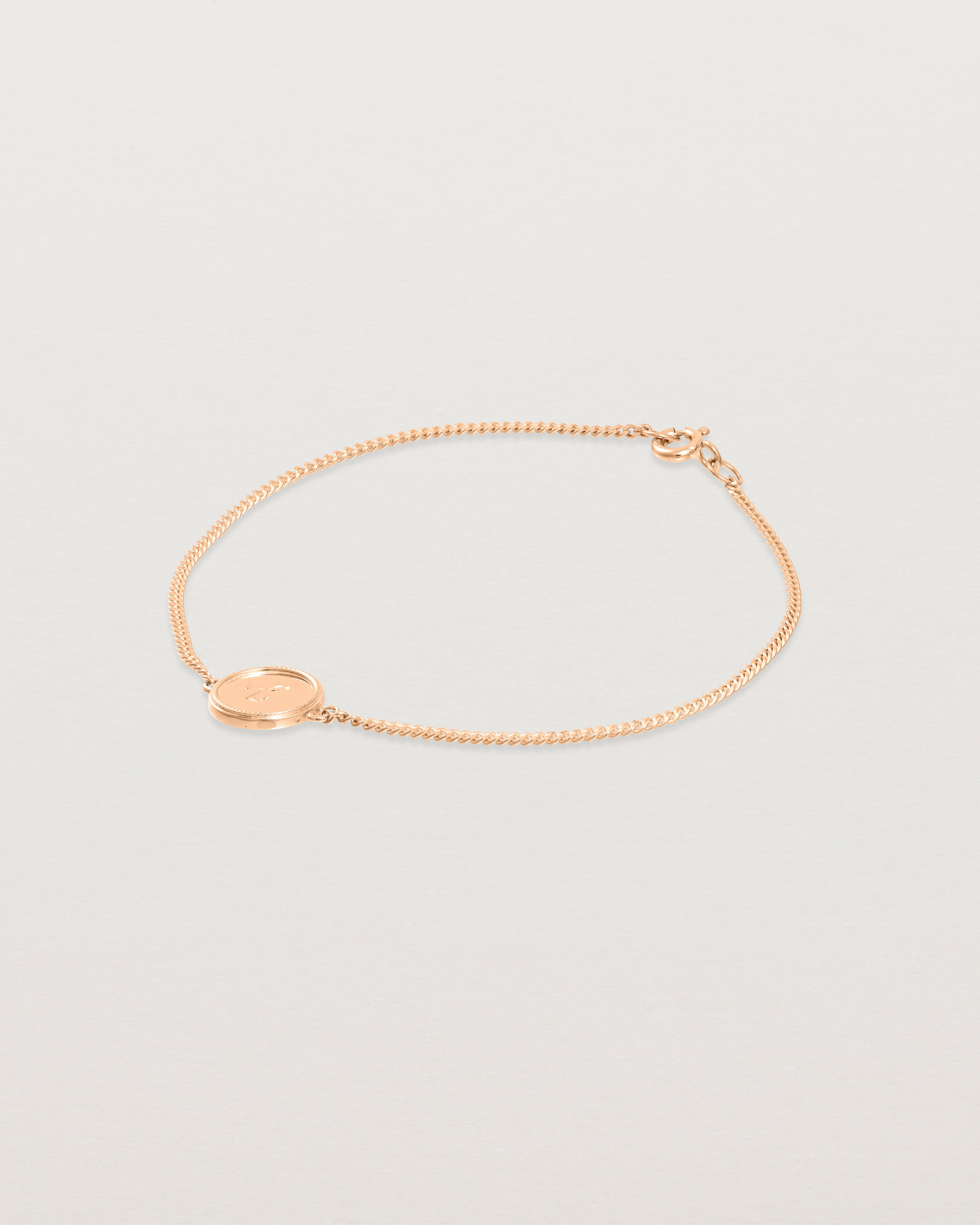 Angled view of the Precious Initial Bracelet in rose gold.