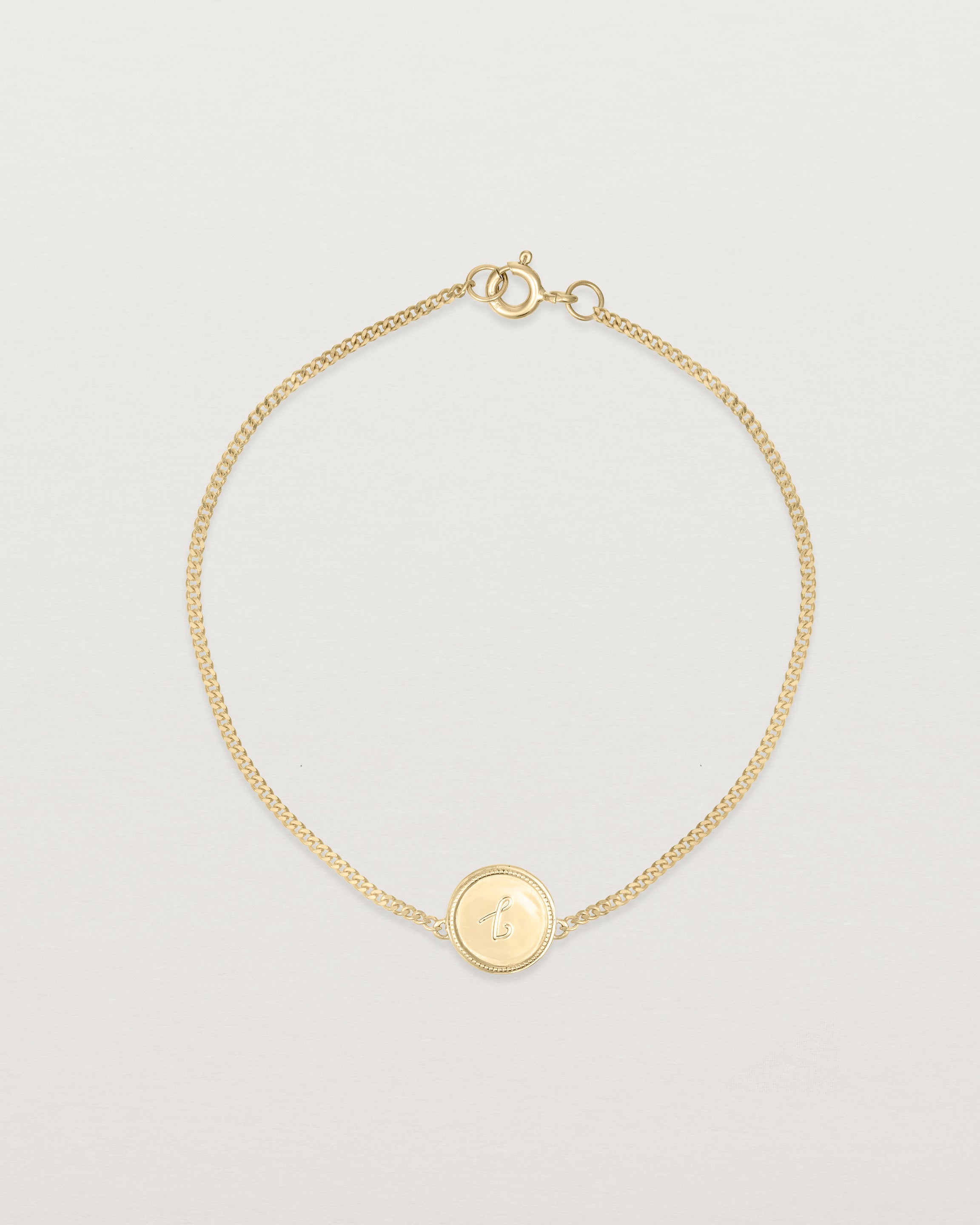 Top down view of the Precious Initial Bracelet in yellow gold.