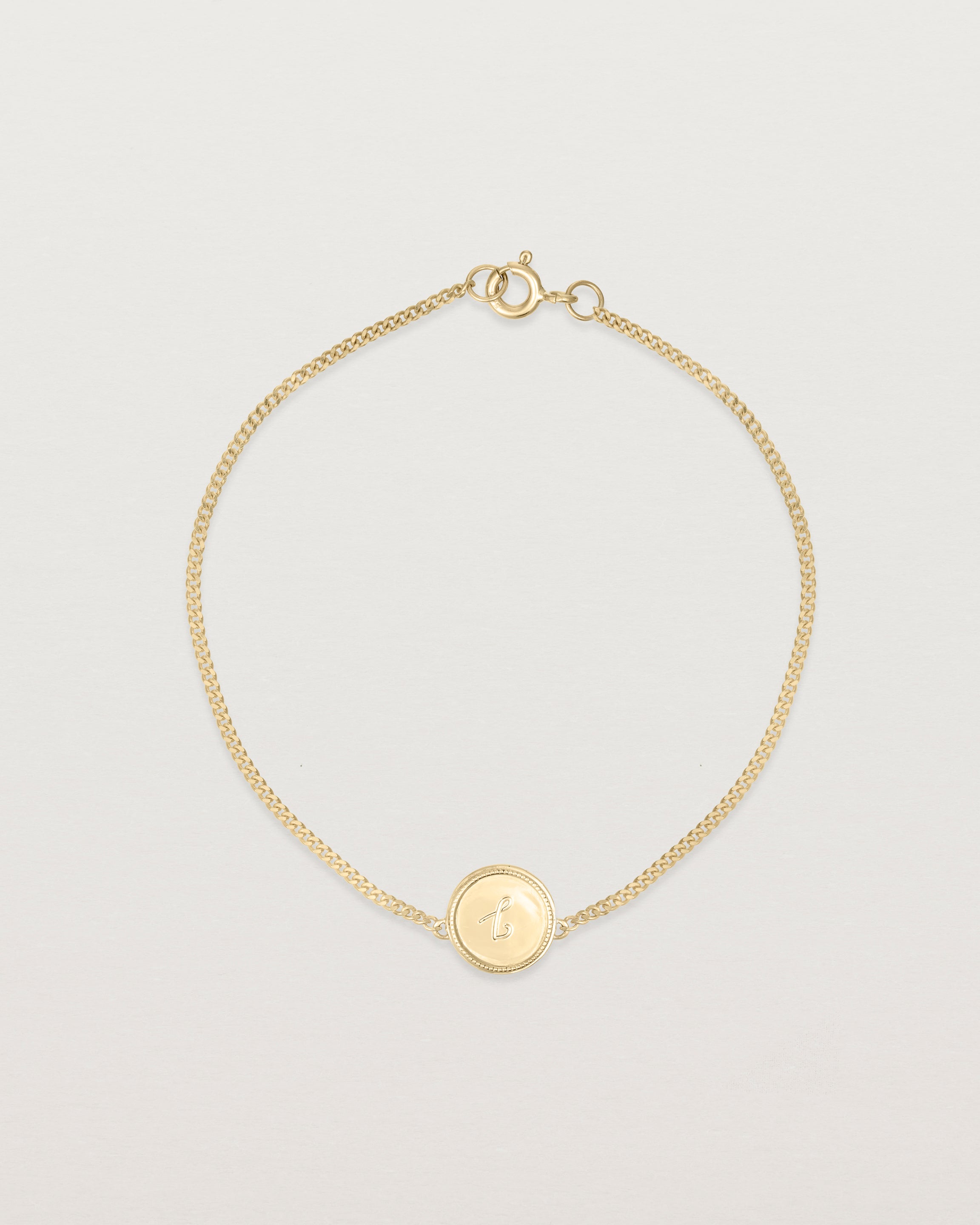 Top down view of the Precious Initial Bracelet in yellow gold.