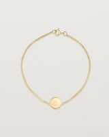 Top down view of the Precious Initial Bracelet in yellow gold.