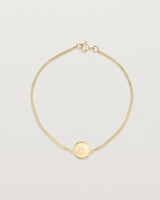 Top down view of the Precious Initial Bracelet in yellow gold.