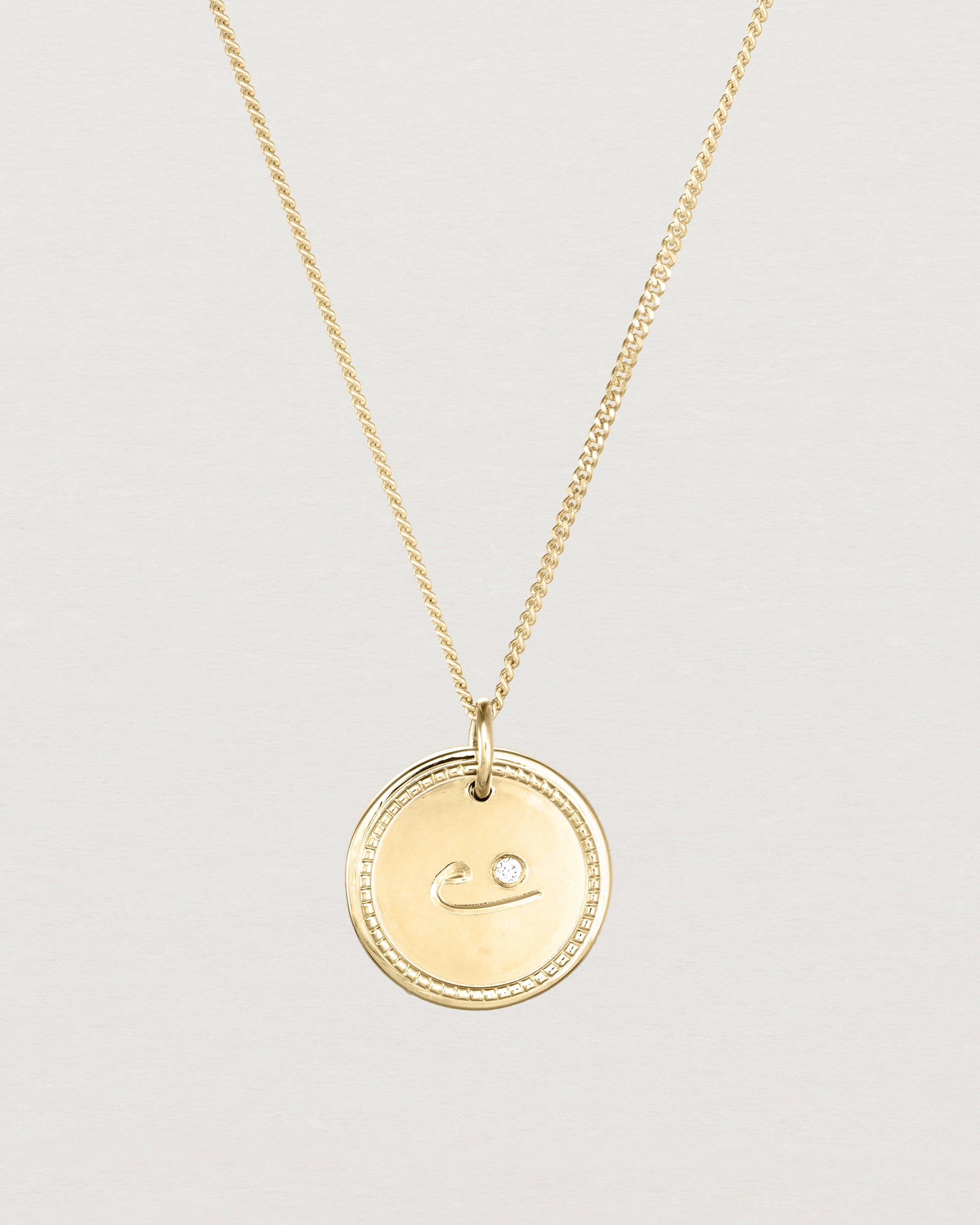Close up view of the Precious Initial Necklace | Birthstone in yellow gold.