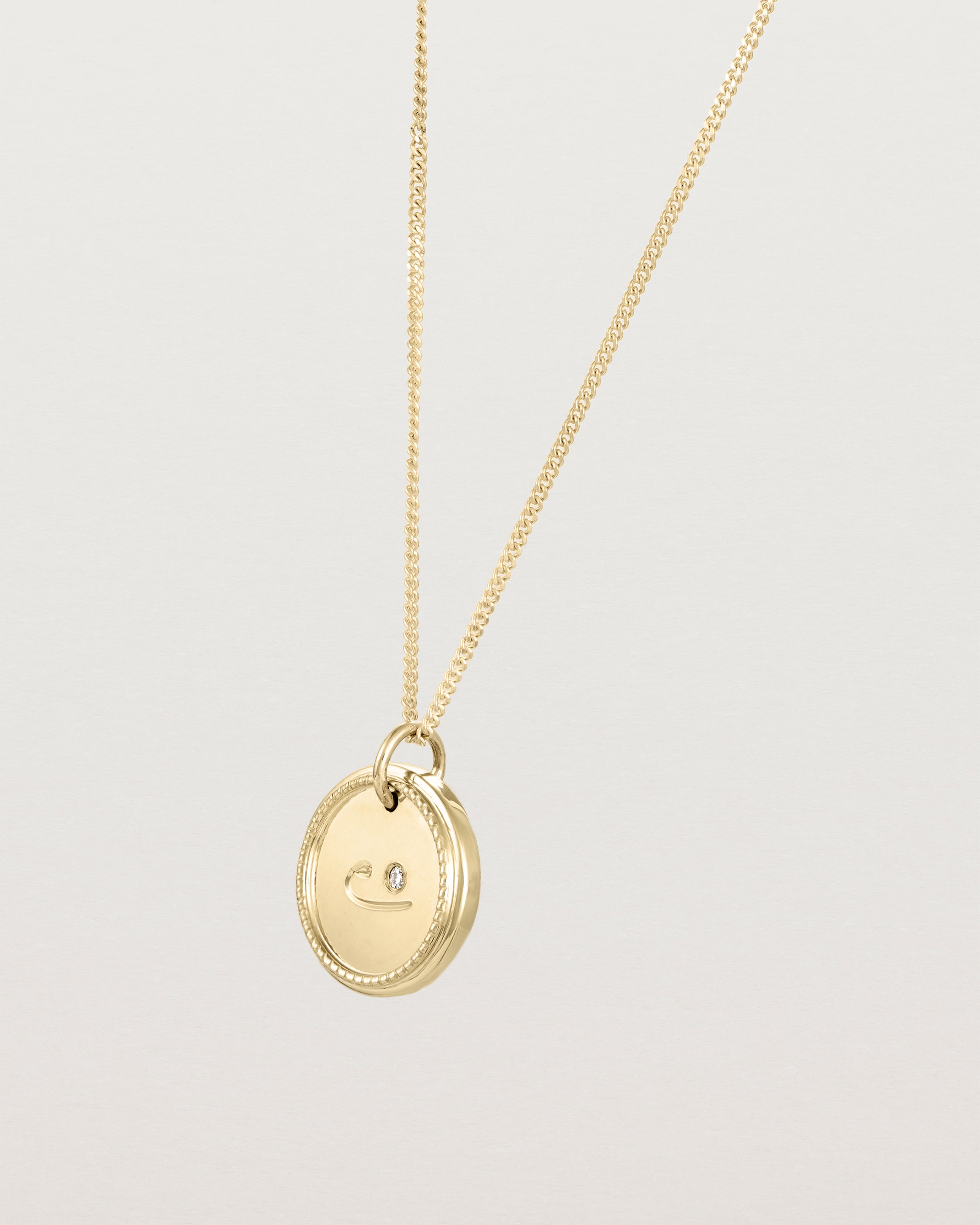 Angled view of the Precious Initial Necklace | Birthstone in yellow gold.