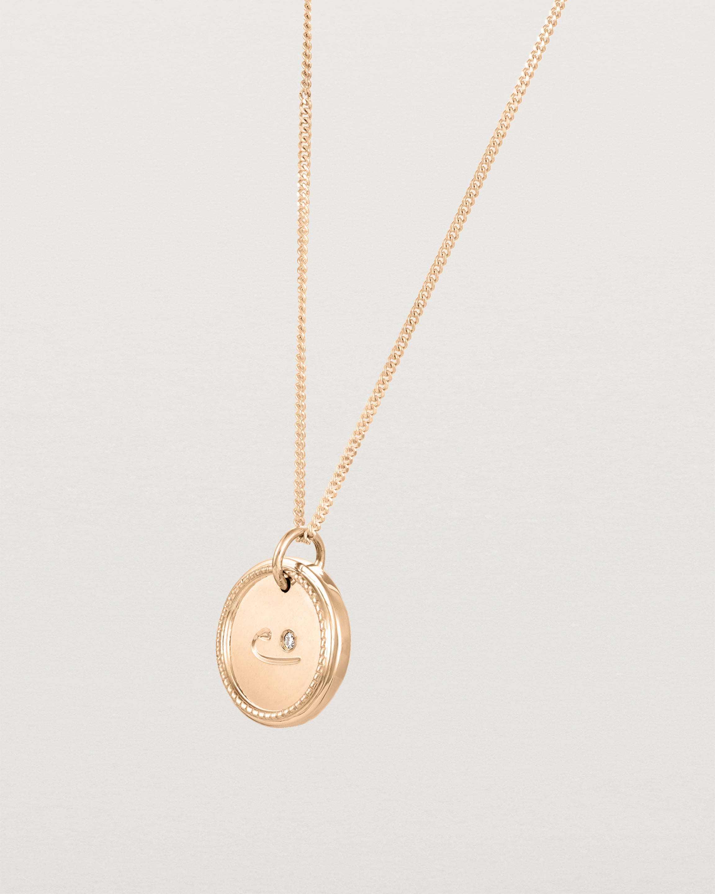 Angled view of the Precious Initial Necklace | Birthstone in rose gold.