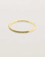A half band of champagne diamonds set on a yellow gold ring
