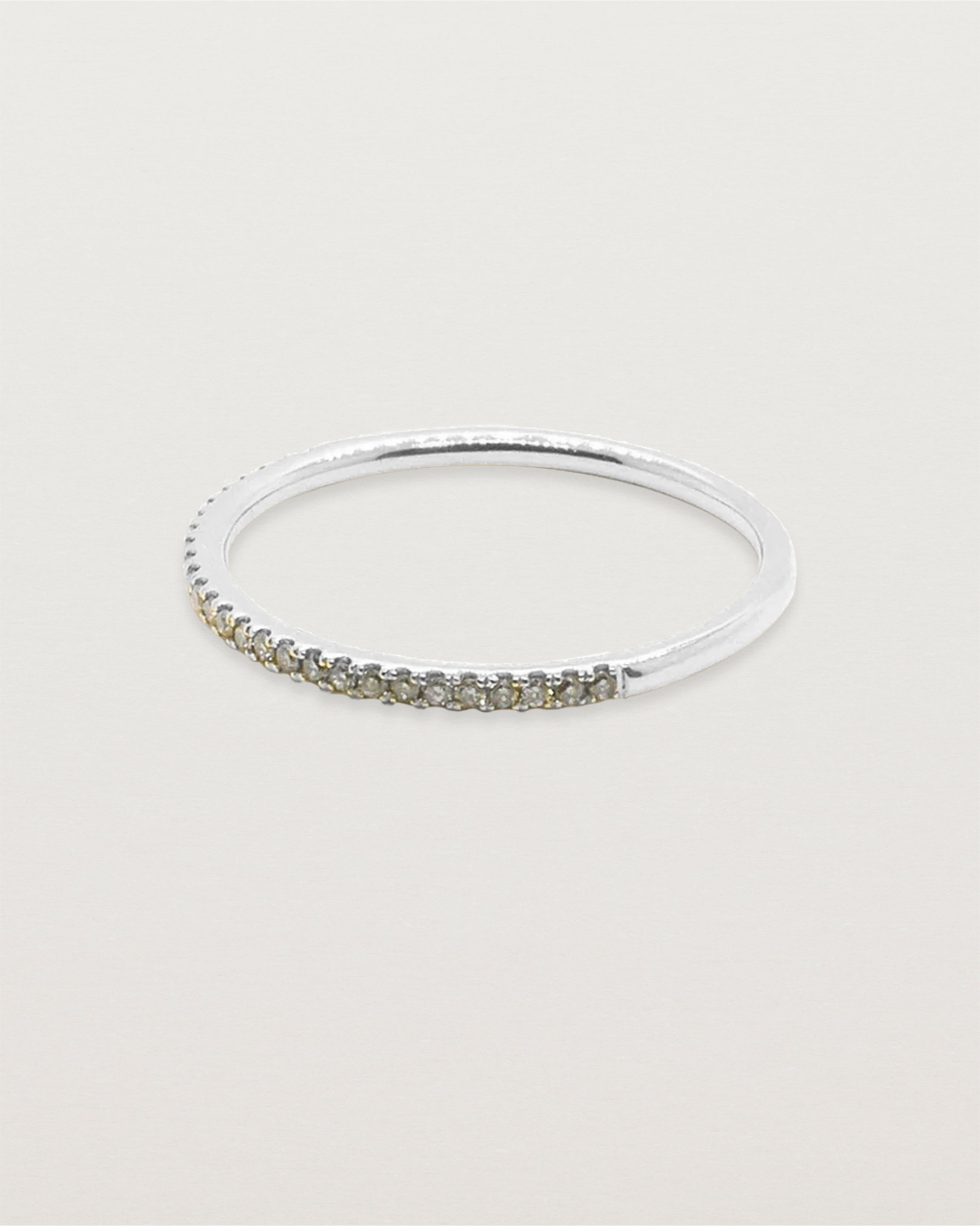 Side view of the Queenie half band with champagne diamonds in white gold