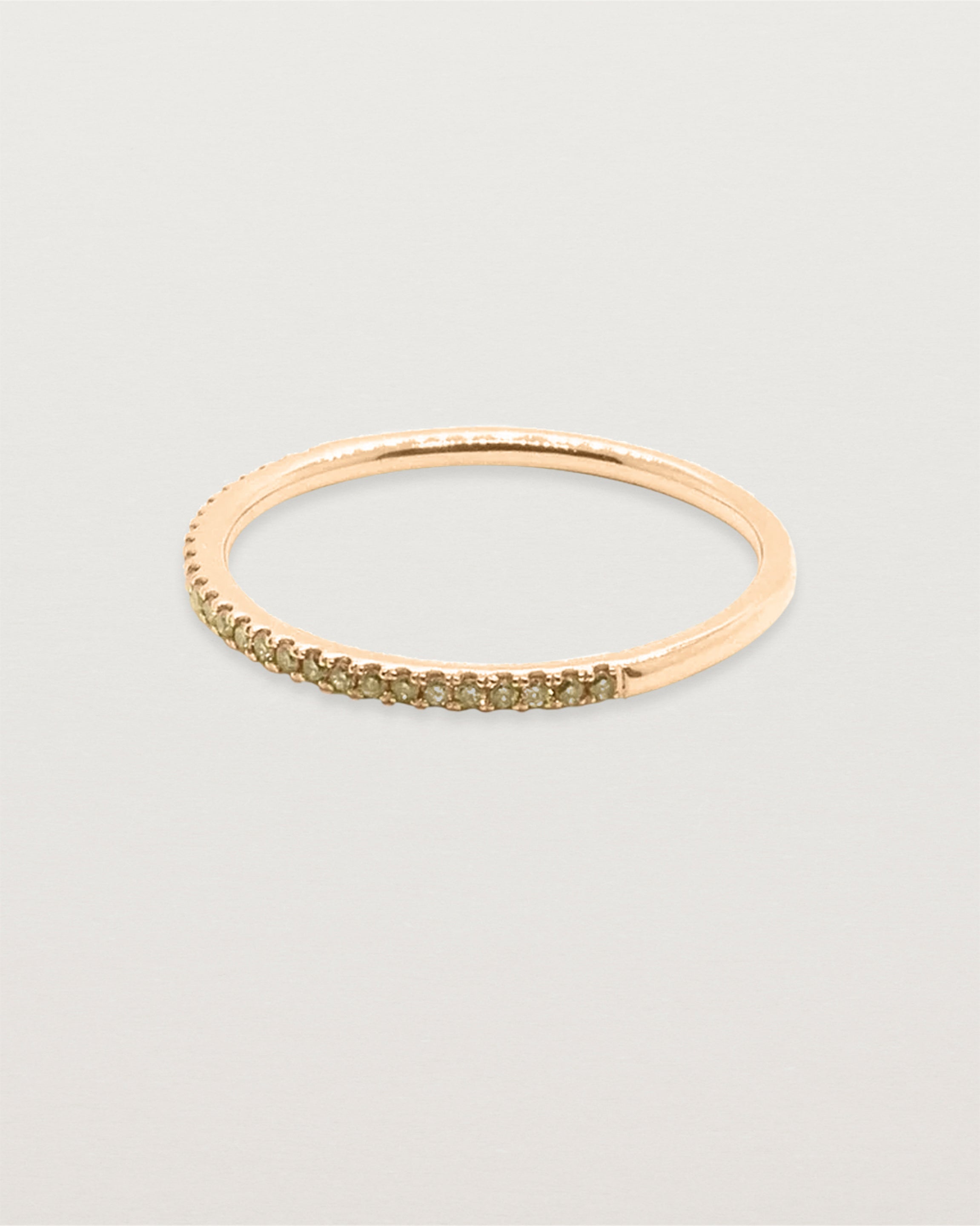 A half band of champagne diamond set on a rose gold band