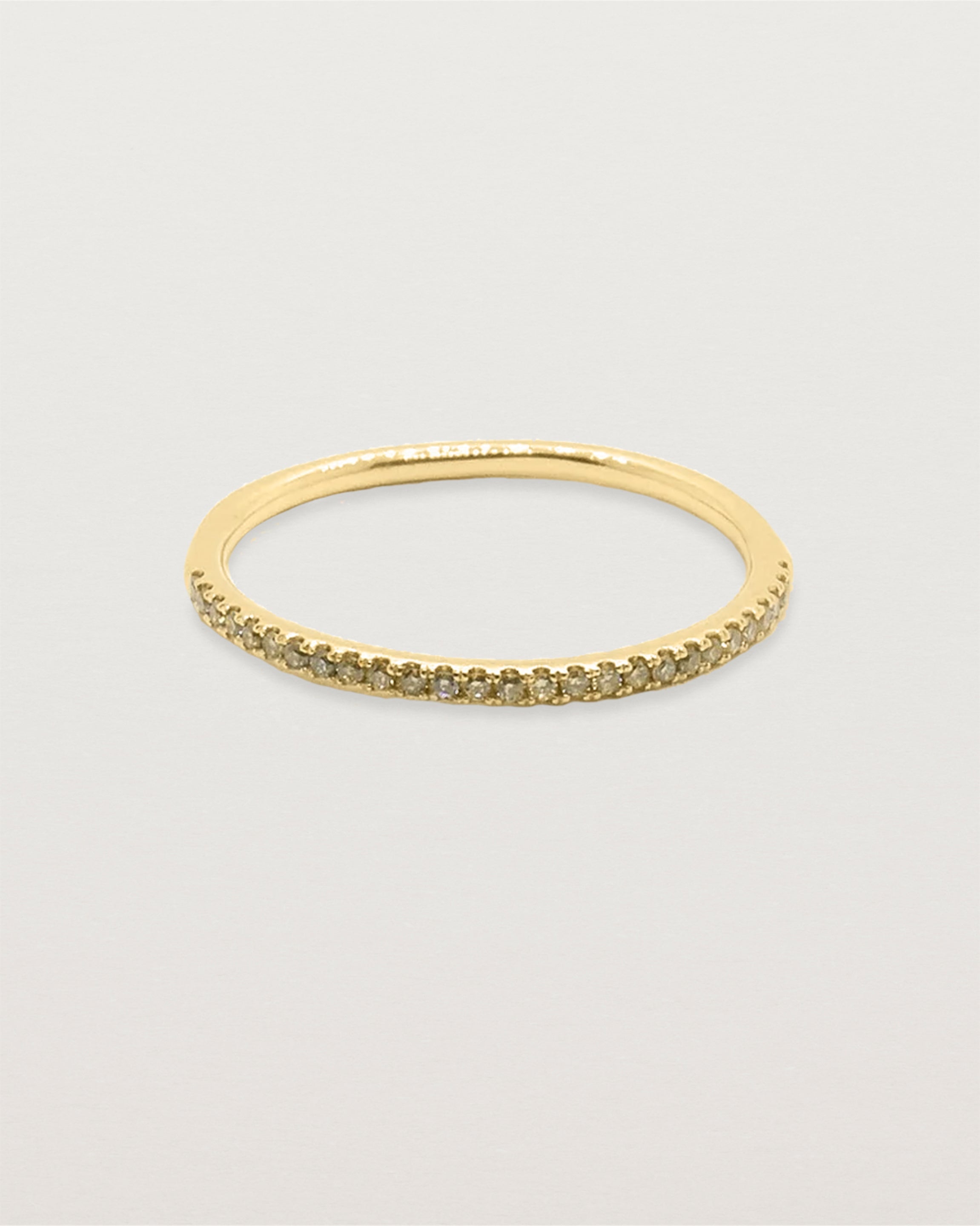 A half band of champagne diamonds set on a yellow gold ring