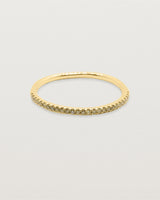 A half band of champagne diamonds set on a yellow gold ring