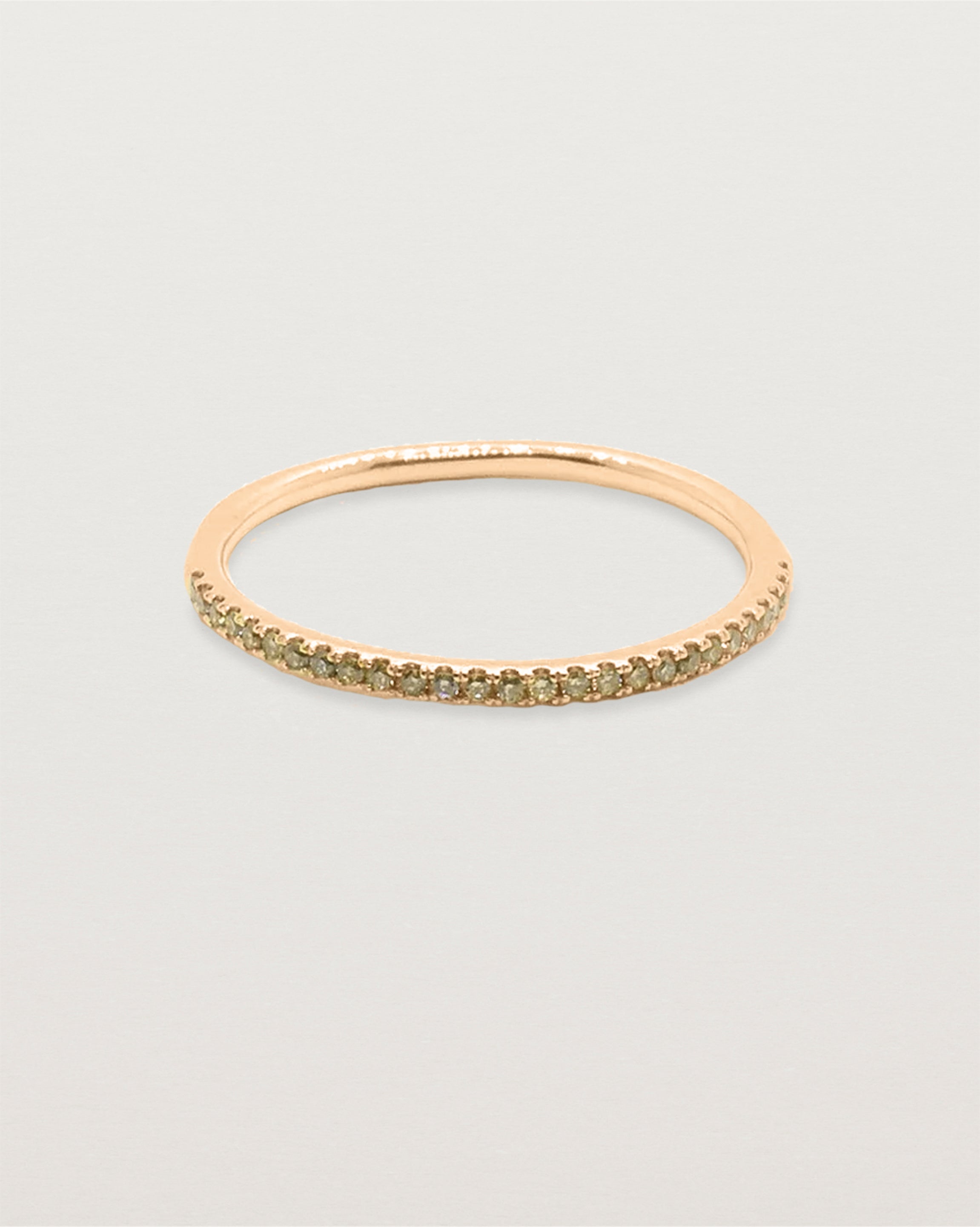 A half band of champagne diamond set on a rose gold band