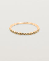 A half band of champagne diamond set on a rose gold band