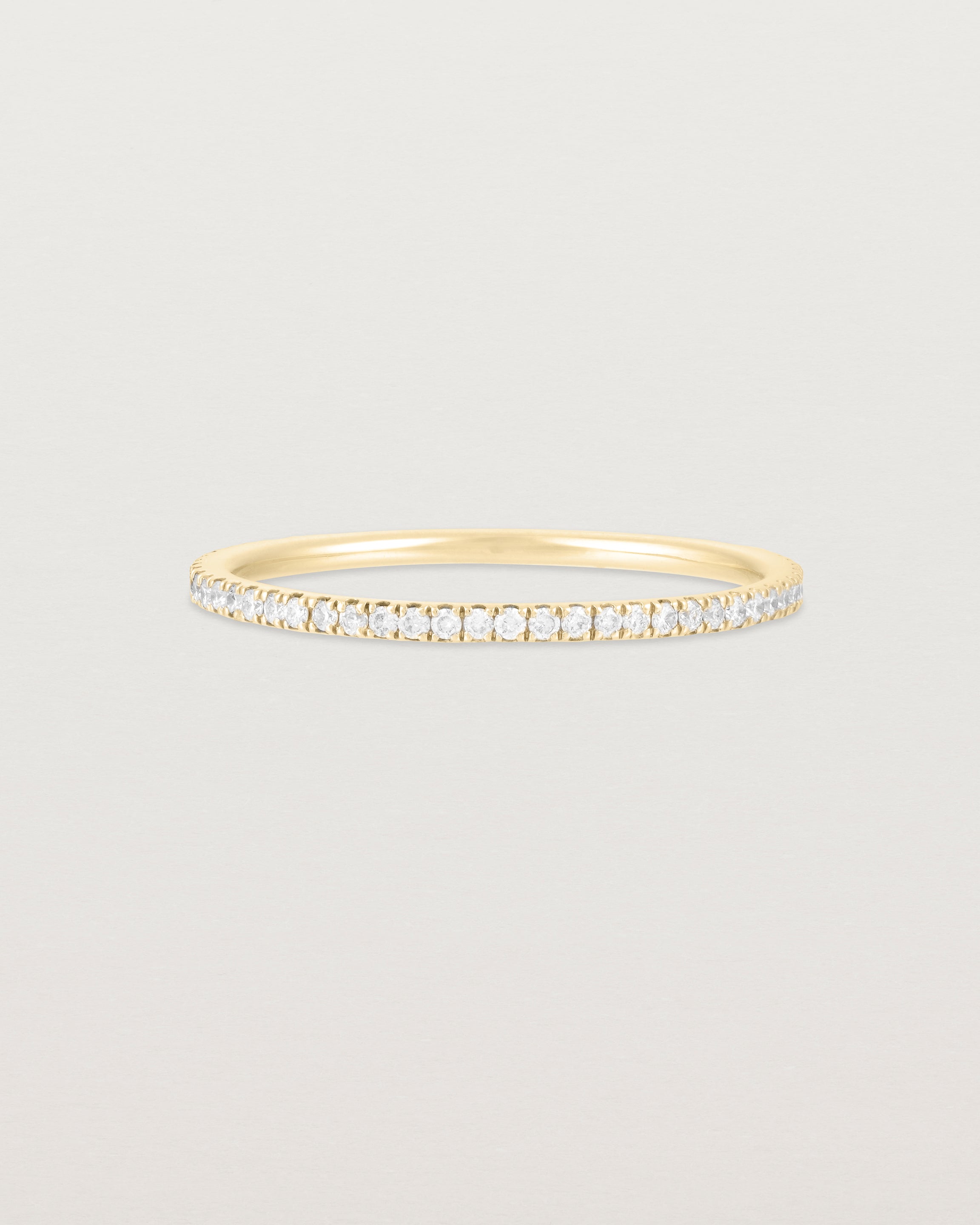 A full yellow gold band featuring white diamonds