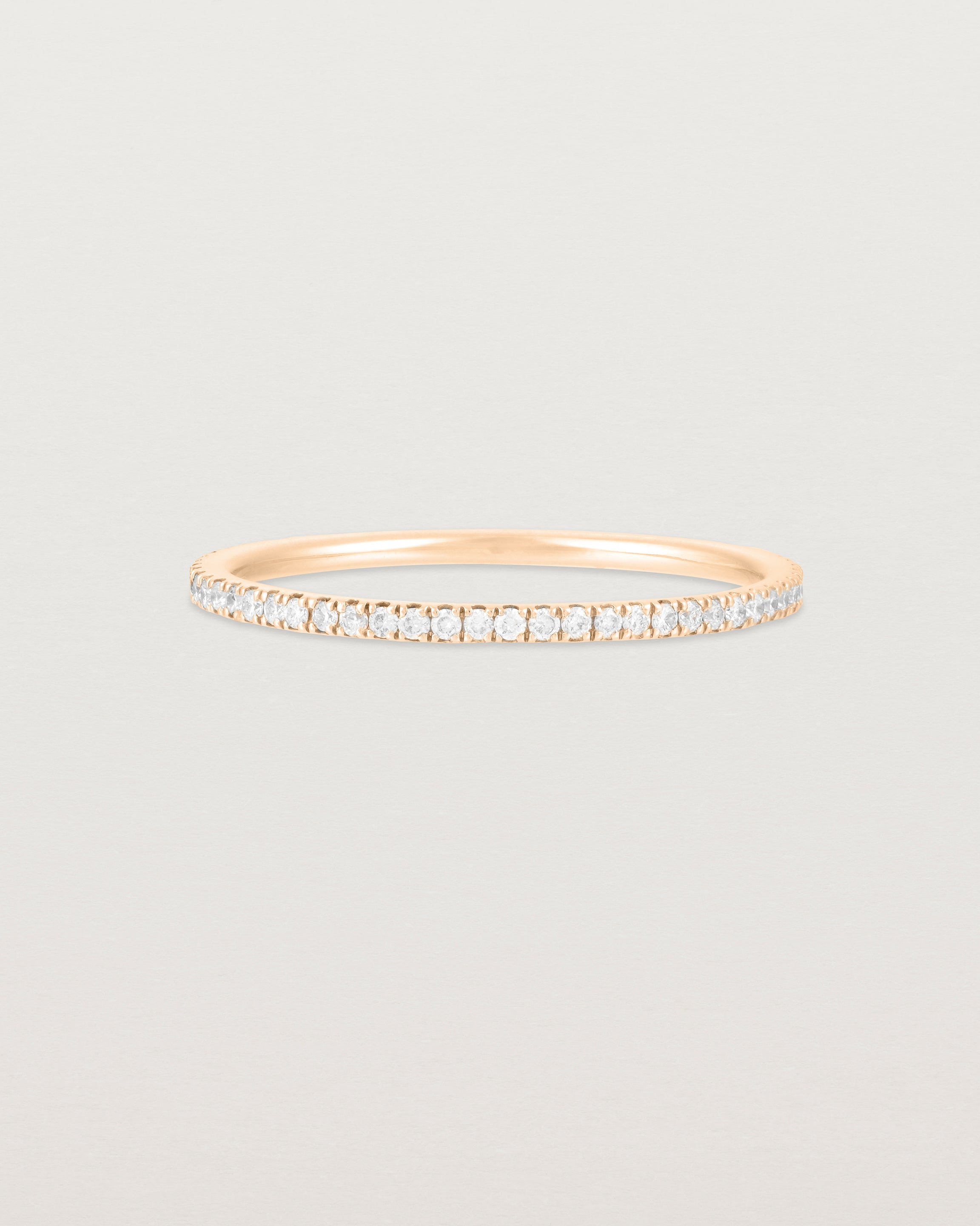 A full rose gold band featuring white diamonds