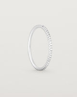 Standing view of a full white gold band featuring white diamonds