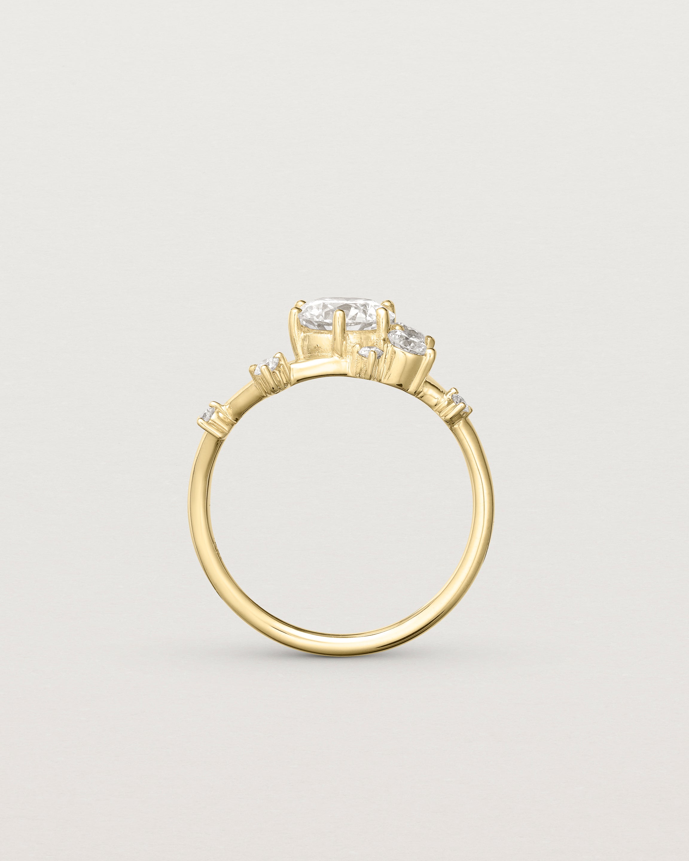 standing deep etched image of a yellow gold  engagement ring with a cluster of laboratory grow diamonds