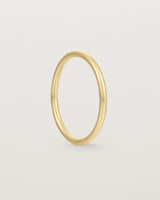 Side view of our fine round wedding band in yellow gold